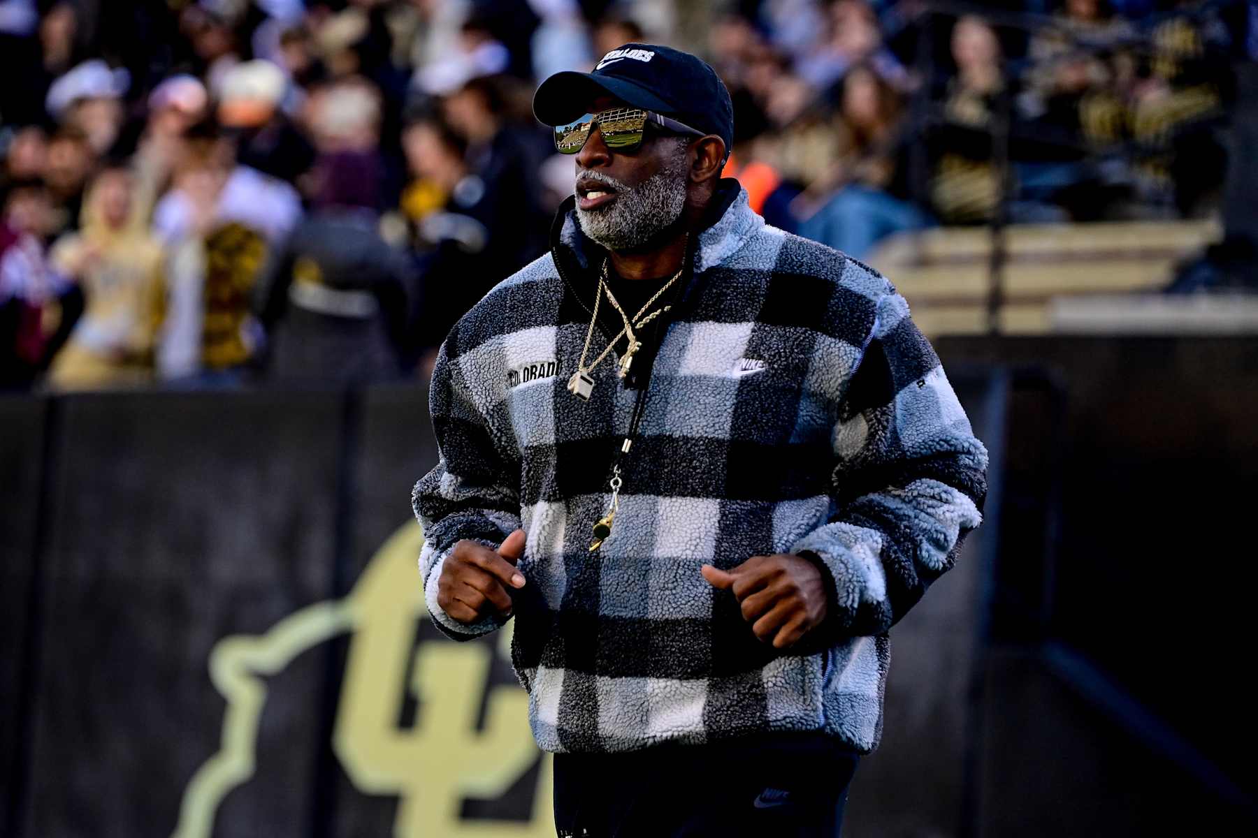BOULDER, CO - NOVEMBER 16:  Head coach Deion Sanders of the Colorado Buffaloes runs on the field before a game between the Colorado Buffaloes and the Utah Utes at Folsom Field on November 16, 2024 in Boulder, Colorado. (Photo by Dustin Bradford/Getty Images)
