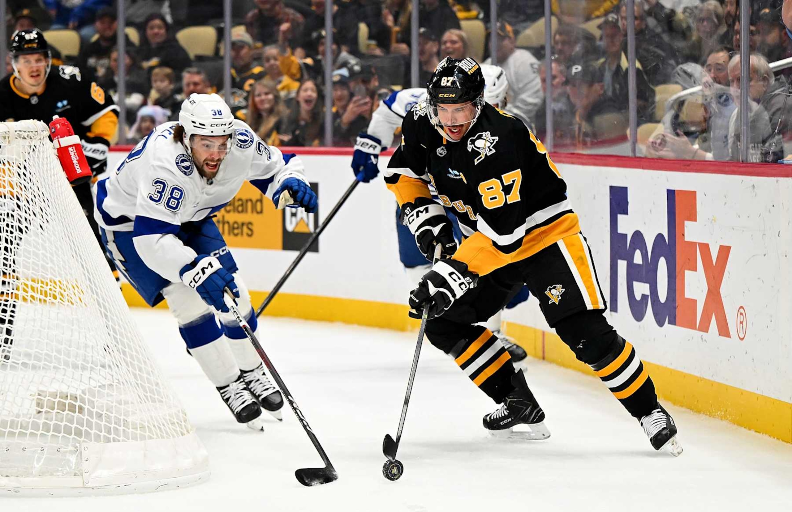 PITTSBURGH, PA - NOVEMBER 19: Sidney Crosby #87 of the Pittsburgh Penguins handles the puck against Brandon Hagel #38 of the Tampa Bay Lightning at PPG PAINTS Arena on November 19, 2024 in Pittsburgh, Pennsylvania. (Photo by Joe Sargent/NHLI via Getty Images) PITTSBURGH, PA - NOVEMBER 19: Sidney Crosby #87 of the Pittsburgh Penguins handles the puck against Brandon Hagel #38 of the Tampa Bay Lightning at PPG PAINTS Arena on November 19, 2024 in Pittsburgh, Pennsylvania. (Photo by Joe Sargent/NHLI via Getty Images)