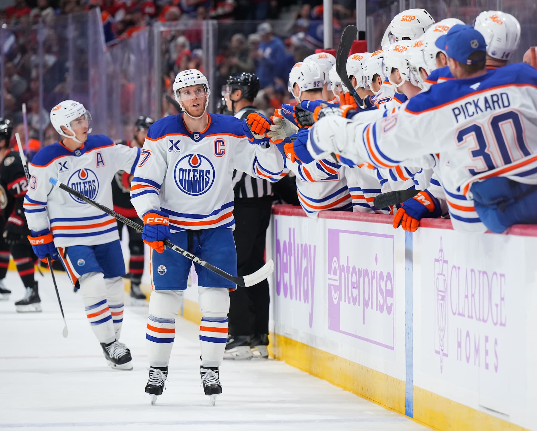 OTTAWA, ON - NOVEMBER 19: Connor McDavid #97 of the Edmonton Oilers celebrates his first period goal against at Canadian Tire Centre with teammates at the players' bench on November 19, 2024 in Ottawa, Ontario, Canada. (Photo by André Ringuette/NHLI via Getty Images)