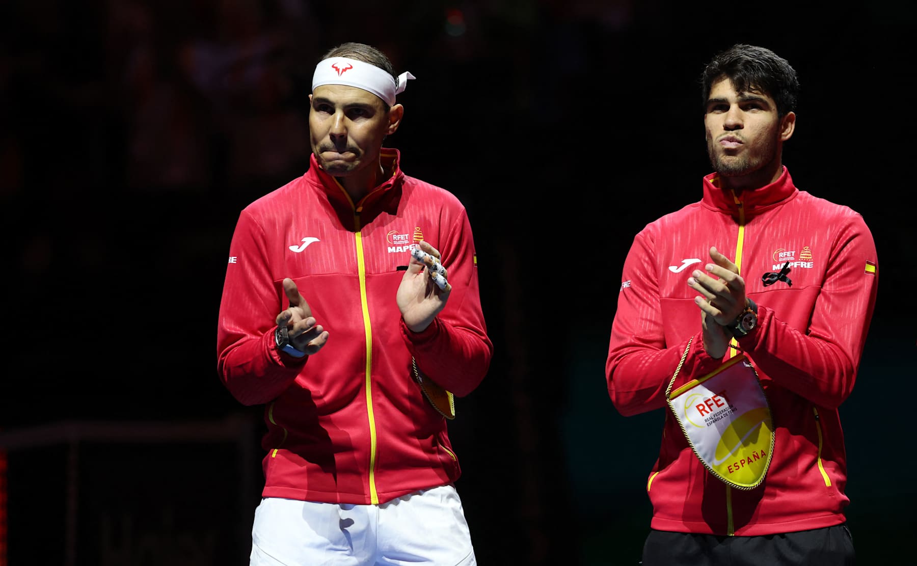 Spain's Rafael Nadal (L) applauds next to Spain's Carlos Alcaraz prior the quarter-final singles match between Netherlands and Spain during the Davis Cup Finals at the Palacio de Deportes Jose Maria Martin Carpena arena in Malaga, southern Spain, on November 19, 2024. The Davis Cup will be the final professional tournament of Nadal's glittering career of almost 23 years. (Photo by Thomas COEX / AFP) (Photo by THOMAS COEX/AFP via Getty Images)
