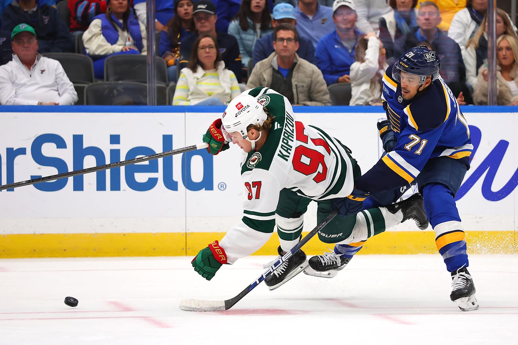 ST LOUIS, MISSOURI - OCTOBER 15: Mathieu Joseph #71 of the St. Louis Blues fights Kirill Kaprizov #97 of the Minnesota Wild for control of the puck in the second period at Enterprise Center on October 15, 2024 in St Louis, Missouri. (Photo by Dilip Vishwanat/Getty Images)