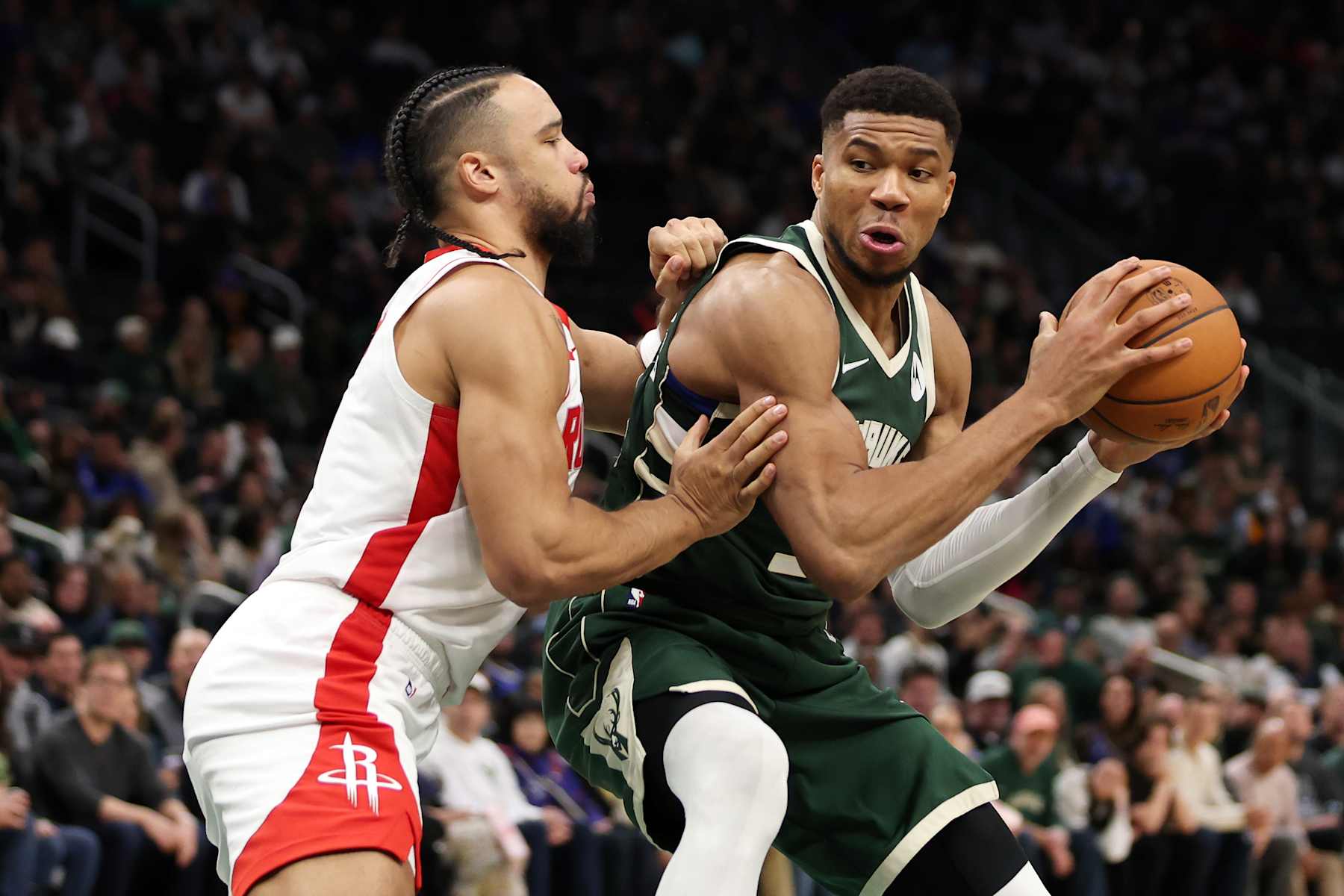 MILWAUKEE, WISCONSIN - NOVEMBER 18: Giannis Antetokounmpo #34 of the Milwaukee Bucks is defended by Dillon Brooks #9 of the Houston Rockets during a game at Fiserv Forum on November 18, 2024 in Milwaukee, Wisconsin. NOTE TO USER: User expressly acknowledges and agrees that, by downloading and or using this photograph, User is consenting to the terms and conditions of the Getty Images License Agreement. (Photo by Stacy Revere/Getty Images)