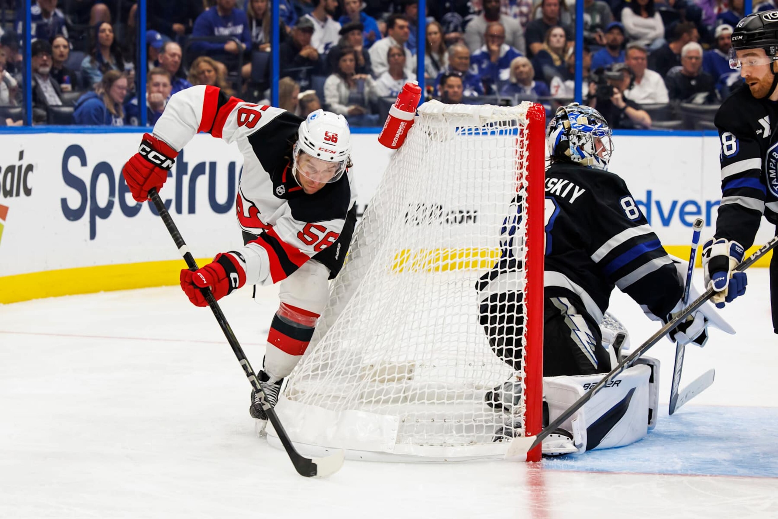 TAMPA, FL - NOVEMBER 16: Goalie Andrei Vasilevskiy #88 of the Tampa Bay Lightning tends net against Erik Haula #56 of the New Jersey Devils during the second period at Amalie Arena on November 16, 2024 in Tampa, Florida. (Photo by Mark LoMoglio/NHLI via Getty Images) TAMPA, FL - NOVEMBER 16: Goalie Andrei Vasilevskiy #88 of the Tampa Bay Lightning tends net against Erik Haula #56 of the New Jersey Devils during the second period at Amalie Arena on November 16, 2024 in Tampa, Florida. (Photo by Mark LoMoglio/NHLI via Getty Images)