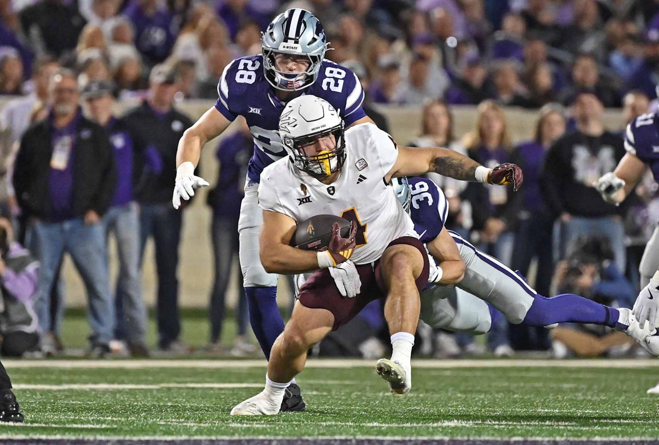 MANHATTAN, KS - NOVEMBER 16:  Running back Cam Skattebo #4 of the Arizona State Sun Devils runs up field past linebacker Rex Van Wyhe #28 of the Kansas State Wildcats in the first half at Bill Snyder Family Football Stadium on November 16, 2024 in Manhattan, Kansas. (Photo by Peter Aiken/Getty Images)