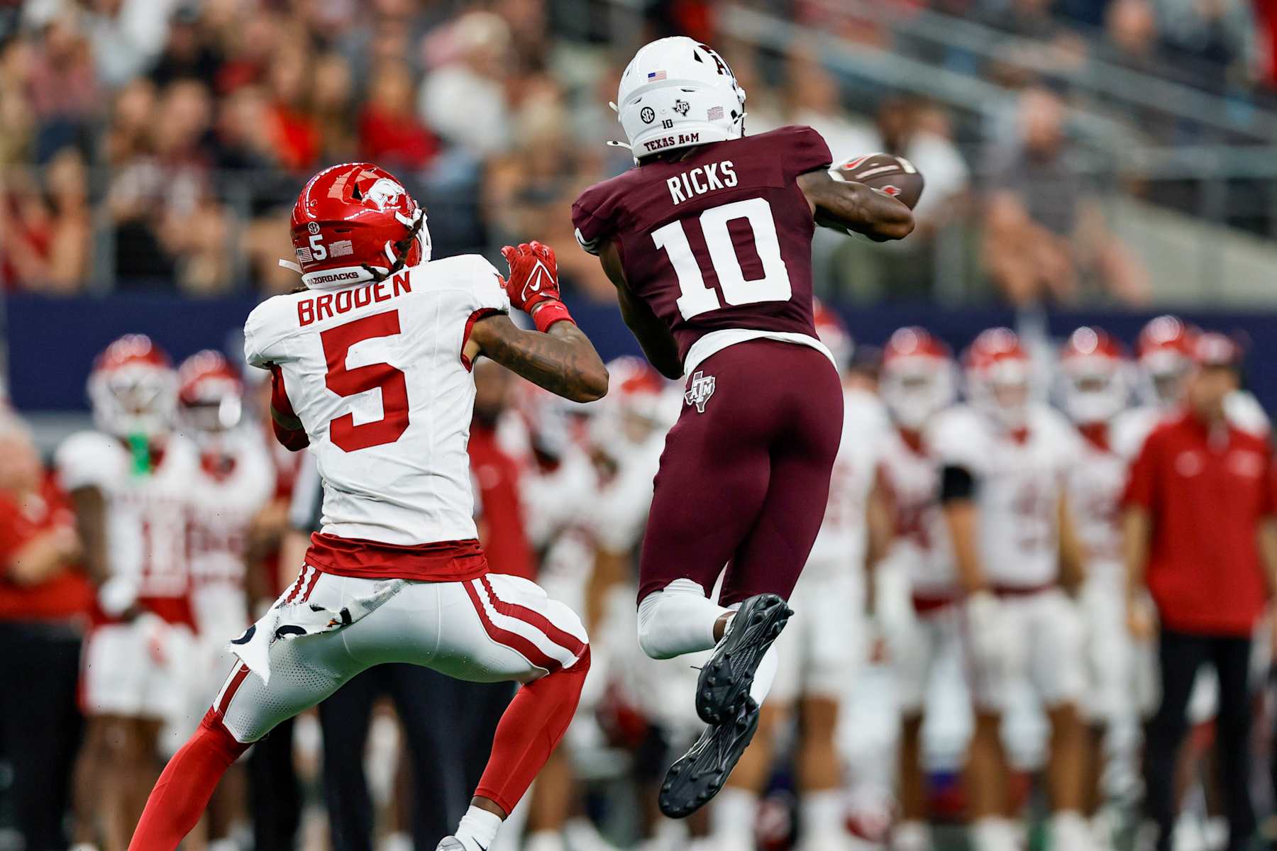 ARLINGTON, TX - SEPTEMBER 28: Texas A&M Aggies defensive back Dezz Ricks (10) steps in front of Arkansas Razorbacks wide receiver Tyrone Broden (5) for an interception during the Southwest Classic game between the Arkansas Razorbacks and the Texas A&M Aggies on September 28, 2024 at AT&T Stadium in Arlington, Texas. (Photo by Matthew Pearce/Icon Sportswire via Getty Images)