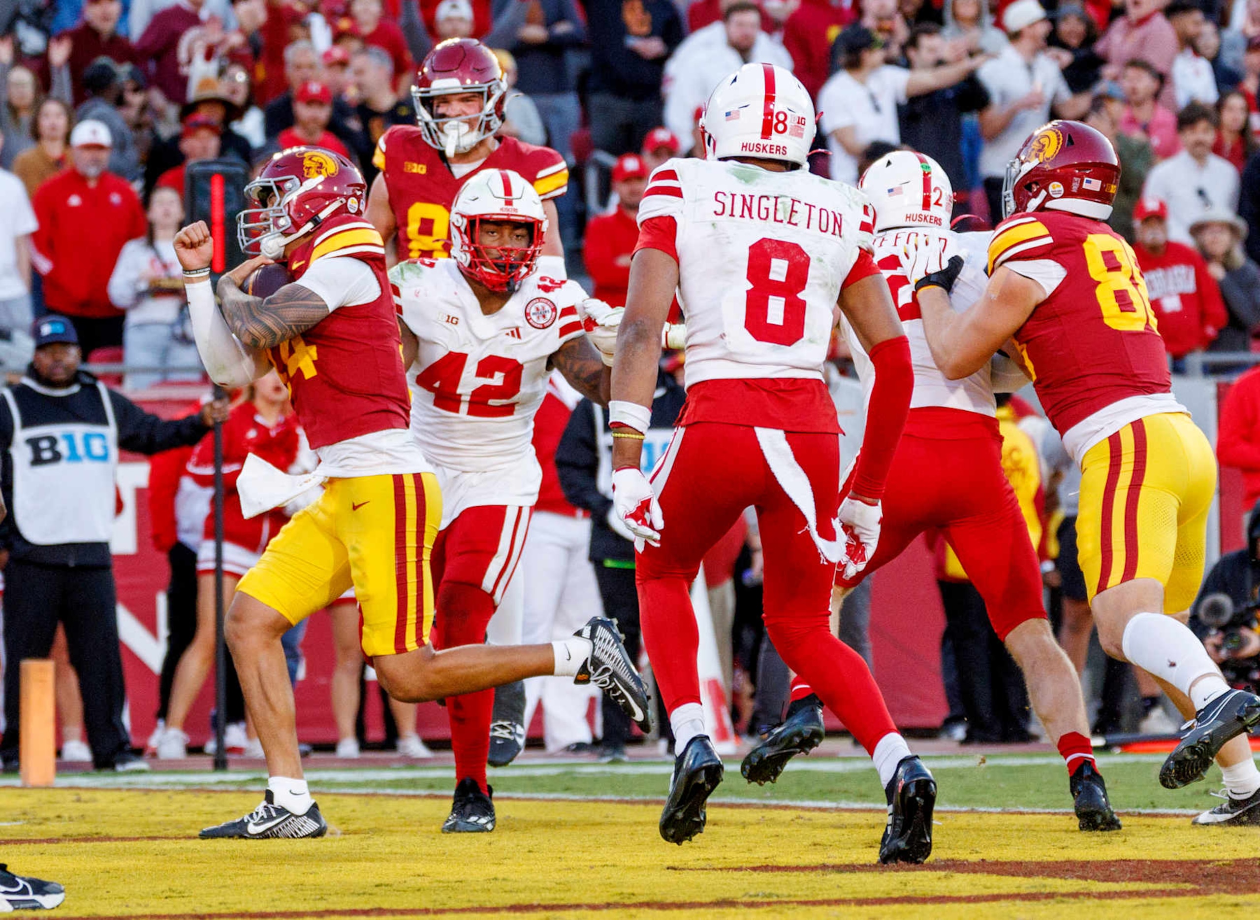 LOS ANGELES, CA - NOVEMBER 16, 2024: *USC Trojans quarterback Jayden Maiava (14) scores on a quarterback-keeper play in front of Nebraska Cornhuskers linebacker Mikai Gbayor (42) in the fourth quarter on November 16, 2024 in Los Angeles, California. (Gina Ferazzi / Los Angeles Times via Getty Images)