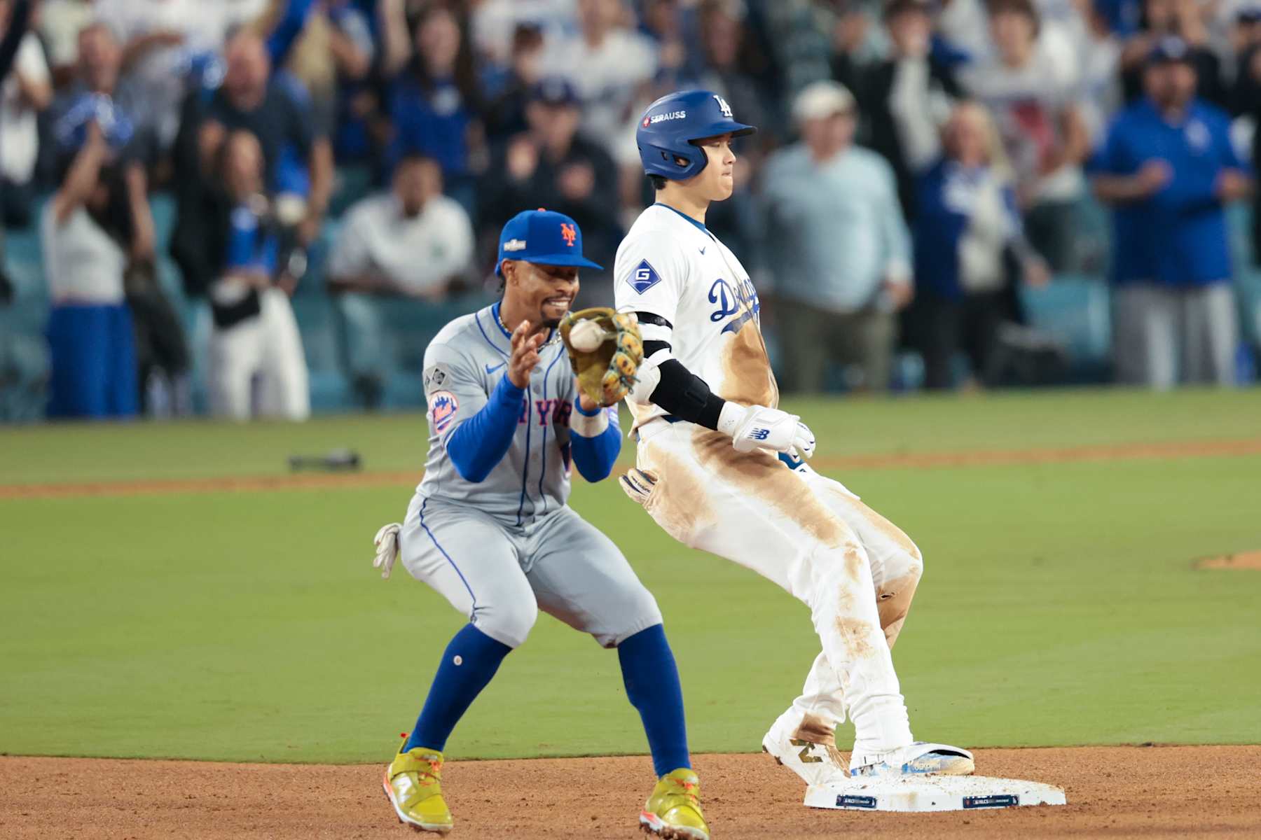 LOS ANGELES, CALIFORNIA - OCTOBER 13: Shohei Ohtani #17 of the Los Angeles Dodgers arrives at second base in front of Francisco Lindor #12 of the New York Mets on an RBI double during the fourth inning in game one of the National League Championship Series at Dodger Stadium on Sunday, Oct. 13, 2024 in Los Angeles. (Wally Skalij / Los Angeles Times via Getty Images)