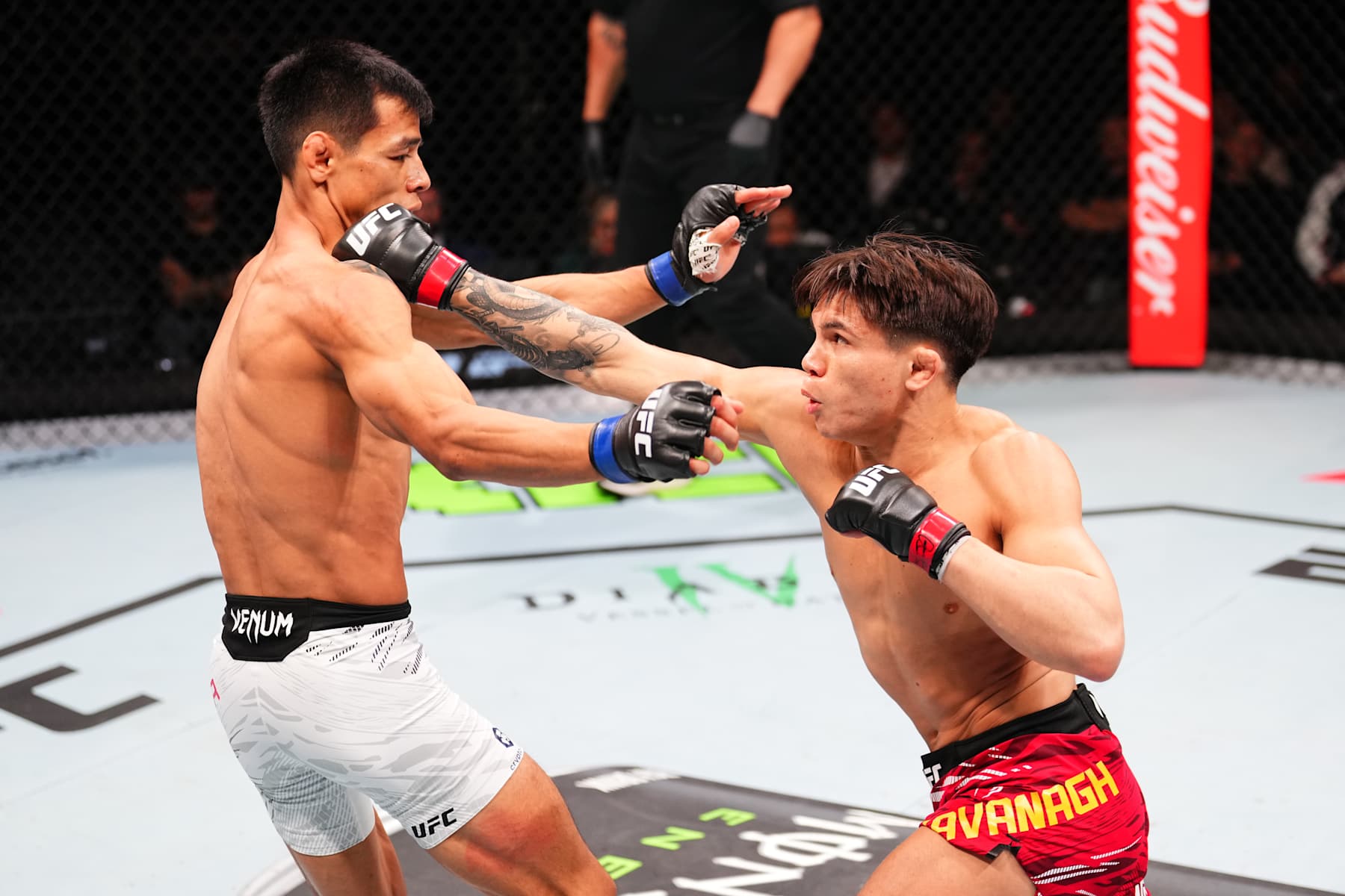 MACAU, CHINA - NOVEMBER 23: (R-L) Lone'er Kavanagh of England punches Jose Ochoa of Peru in their flyweight fight during the UFC Fight Night event at Galaxy Arena on November 23, 2024 in Macau, China. (Photo by Jeff Bottari/Zuffa LLC)