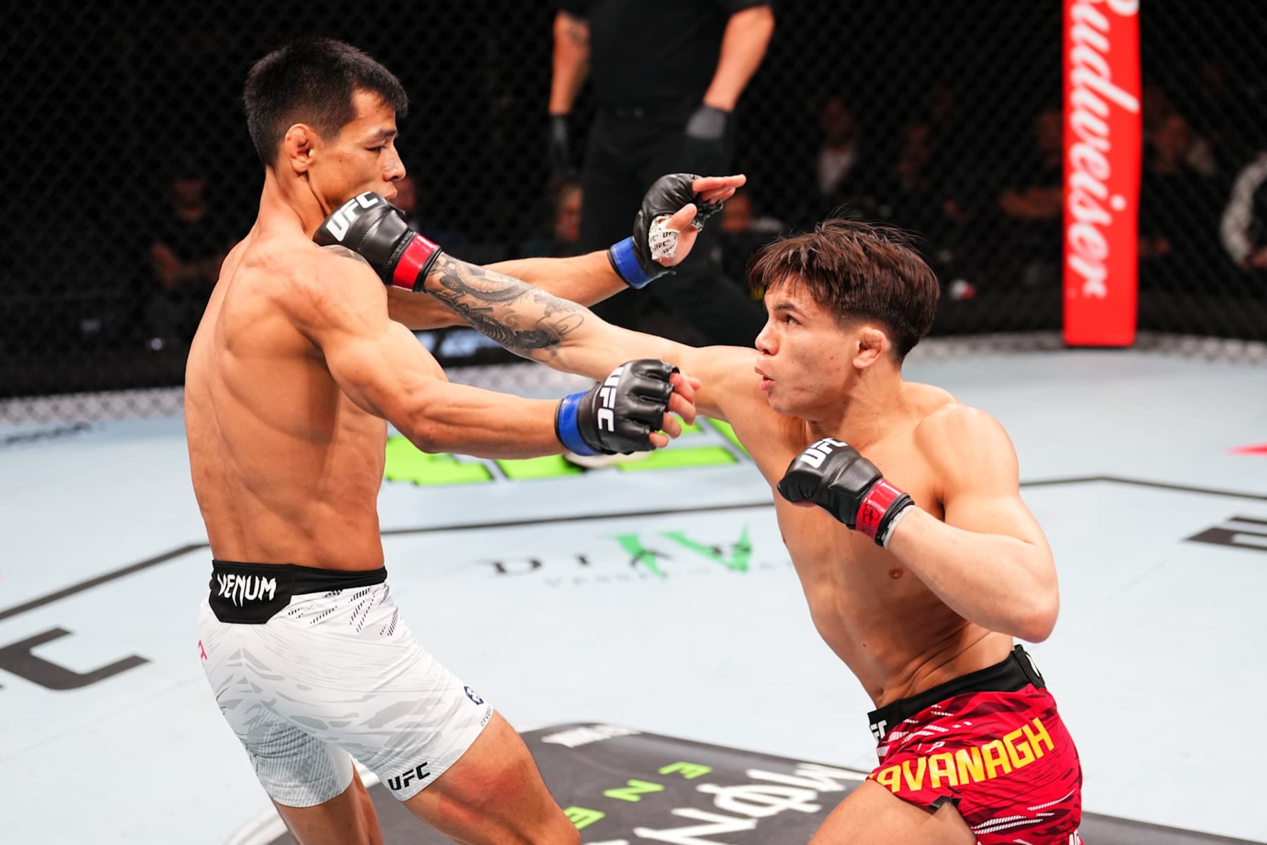 MACAU, CHINA - NOVEMBER 23:  (R-L) Lone'er Kavanagh of England punches Jose Ochoa of Peru in their flyweight fight during the UFC Fight Night event at Galaxy Arena on November 23, 2024 in Macau, China. (Photo by Jeff Bottari/Zuffa LLC)
