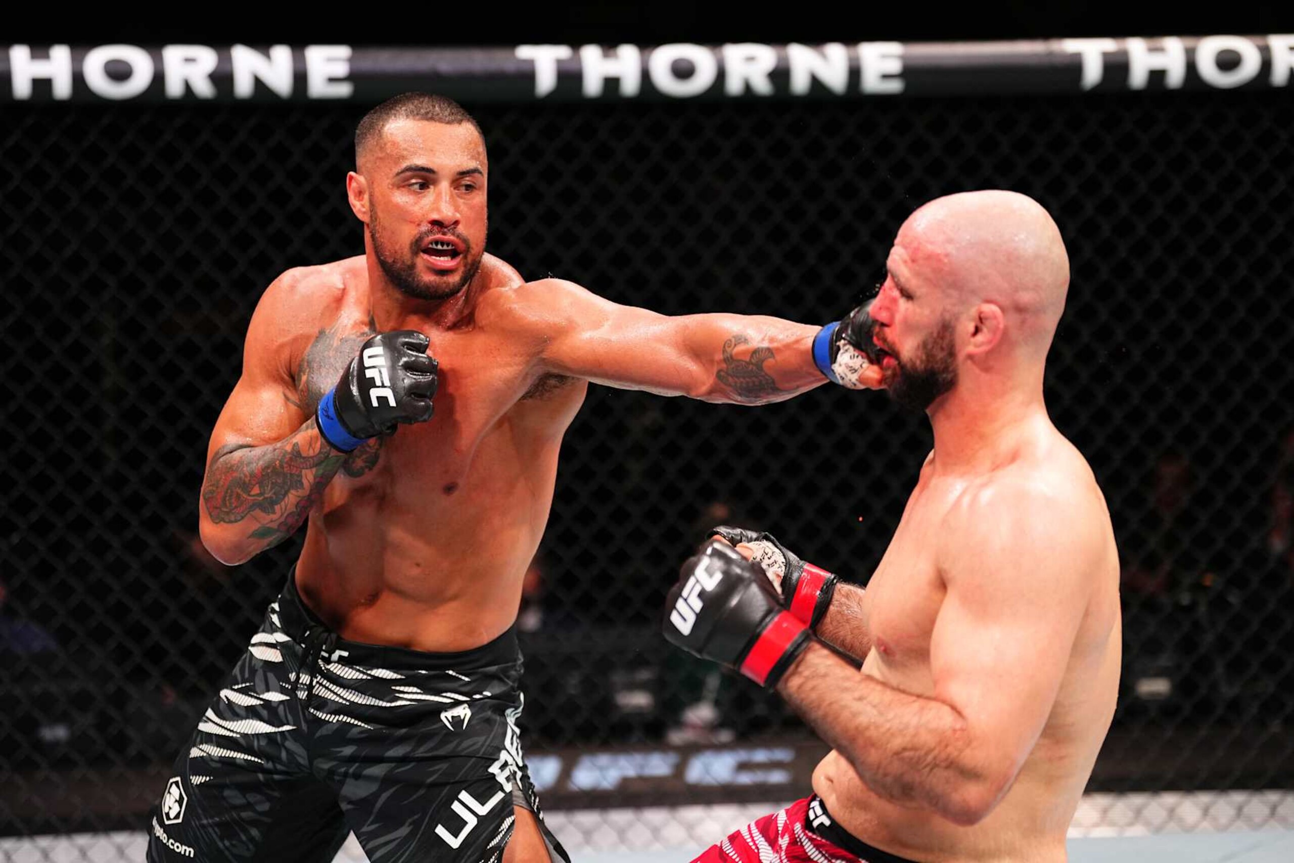 MACAU, CHINA - NOVEMBER 23:  (L-R) Carlos Ulberg of New Zealand punches Volkan Oezdemir of Switzerland in their light heavyweight fight during the UFC Fight Night event at Galaxy Arena on November 23, 2024 in Macau, China. (Photo by Jeff Bottari/Zuffa LLC)