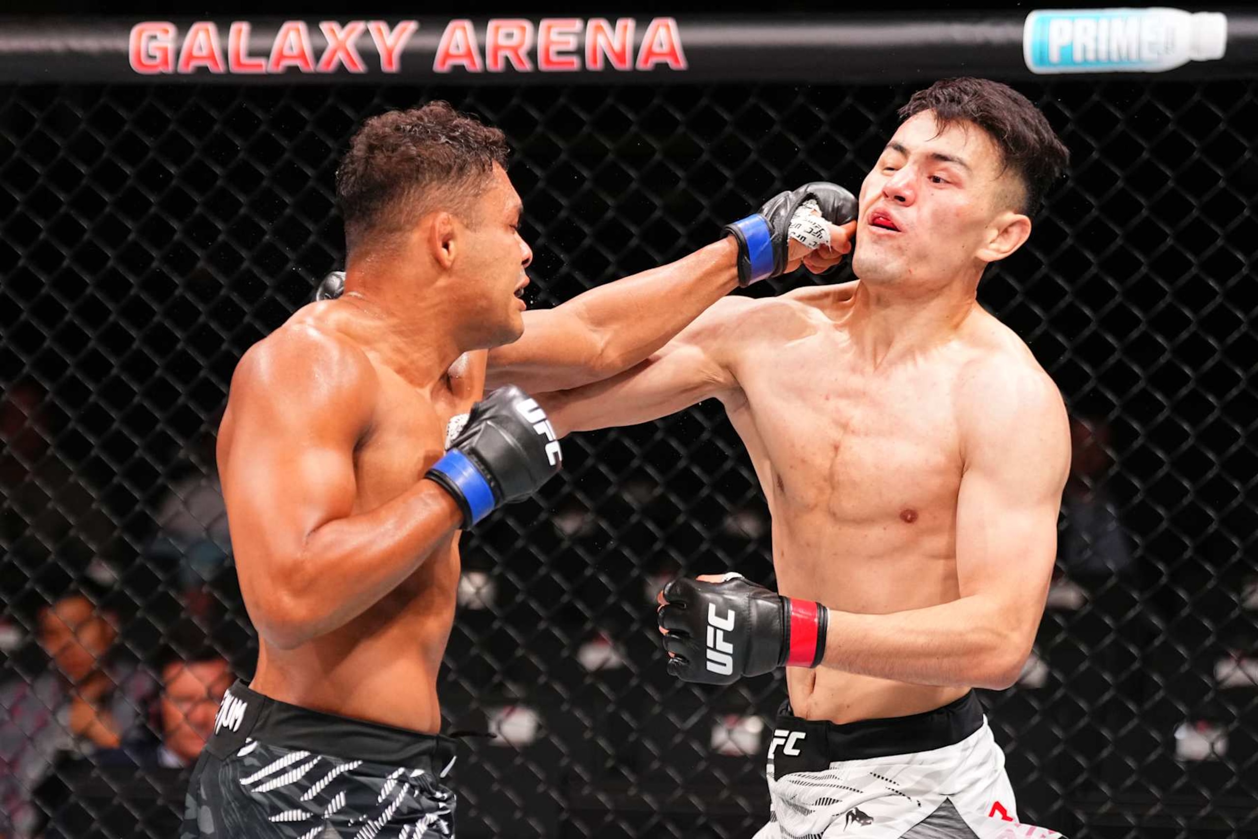 MACAU, CHINA - NOVEMBER 23:  (L-R) Nikolas Motta of Brazil punches Maheshate of China in their lightweight fight during the UFC Fight Night event at Galaxy Arena on November 23, 2024 in Macau, China. (Photo by Jeff Bottari/Zuffa LLC)