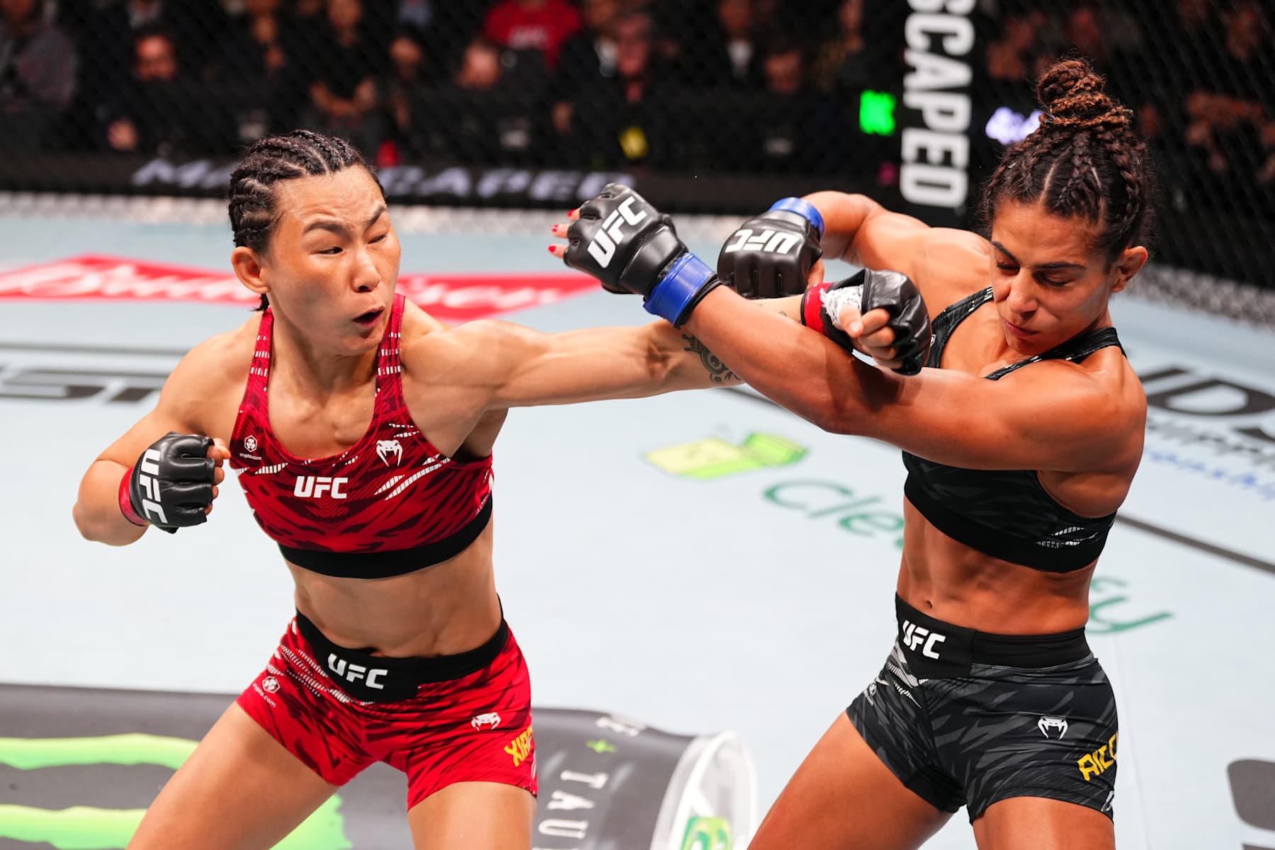 MACAU, CHINA - NOVEMBER 23: (L-) Yan Xiaonan of China punches Tabatha Ricci of Brazil in their women's strawweight fight during the UFC Fight Night event at Galaxy Arena on November 23, 2024 in Macau, China. (Photo by Jeff Bottari/Zuffa LLC)