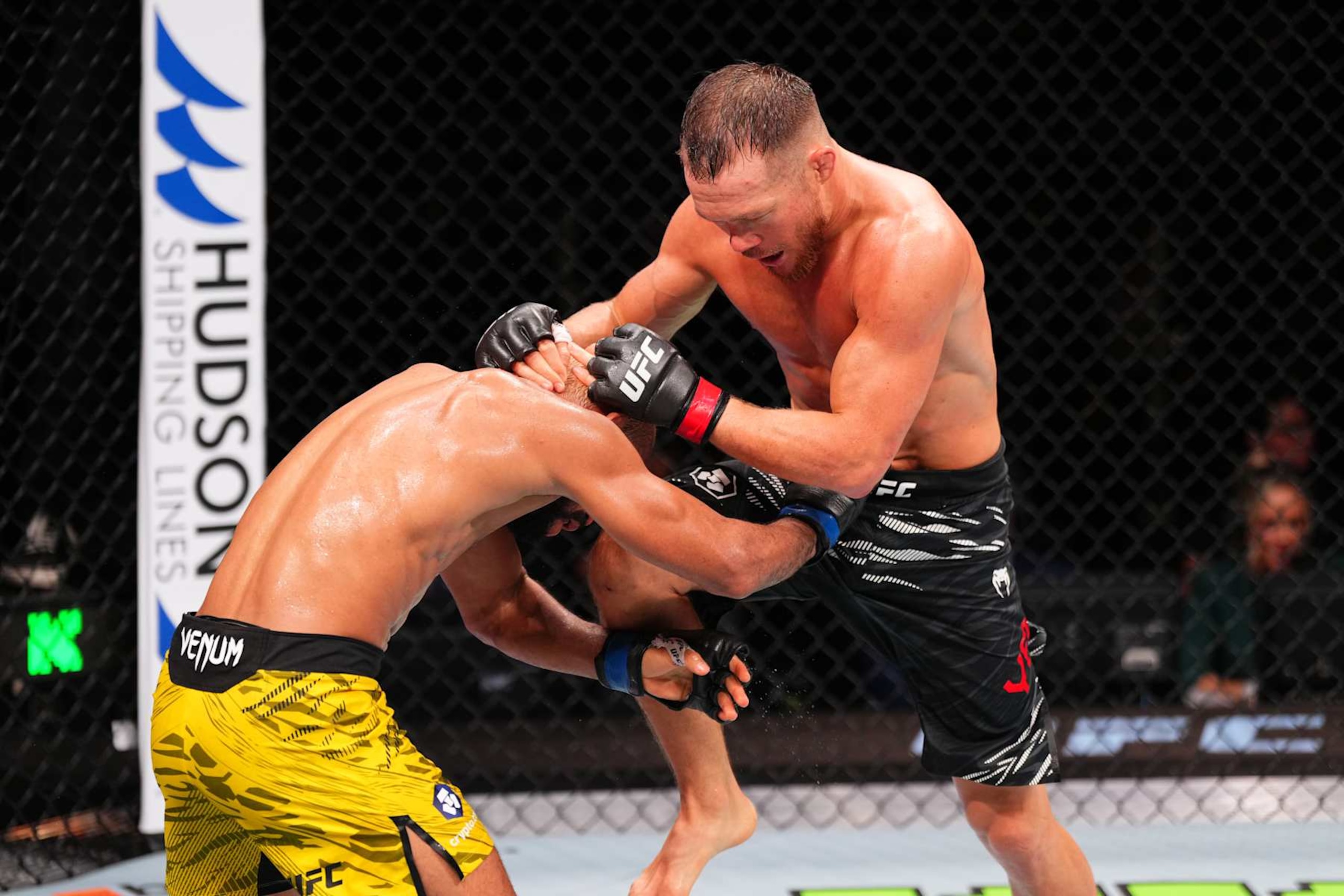 MACAU, CHINA - NOVEMBER 23:  (R-L) Petr Yan of Russia knees Deiveson Figueiredo of Brazil in their bantamweight fight during the UFC Fight Night event at Galaxy Arena on November 23, 2024 in Macau, China. (Photo by Jeff Bottari/Zuffa LLC)