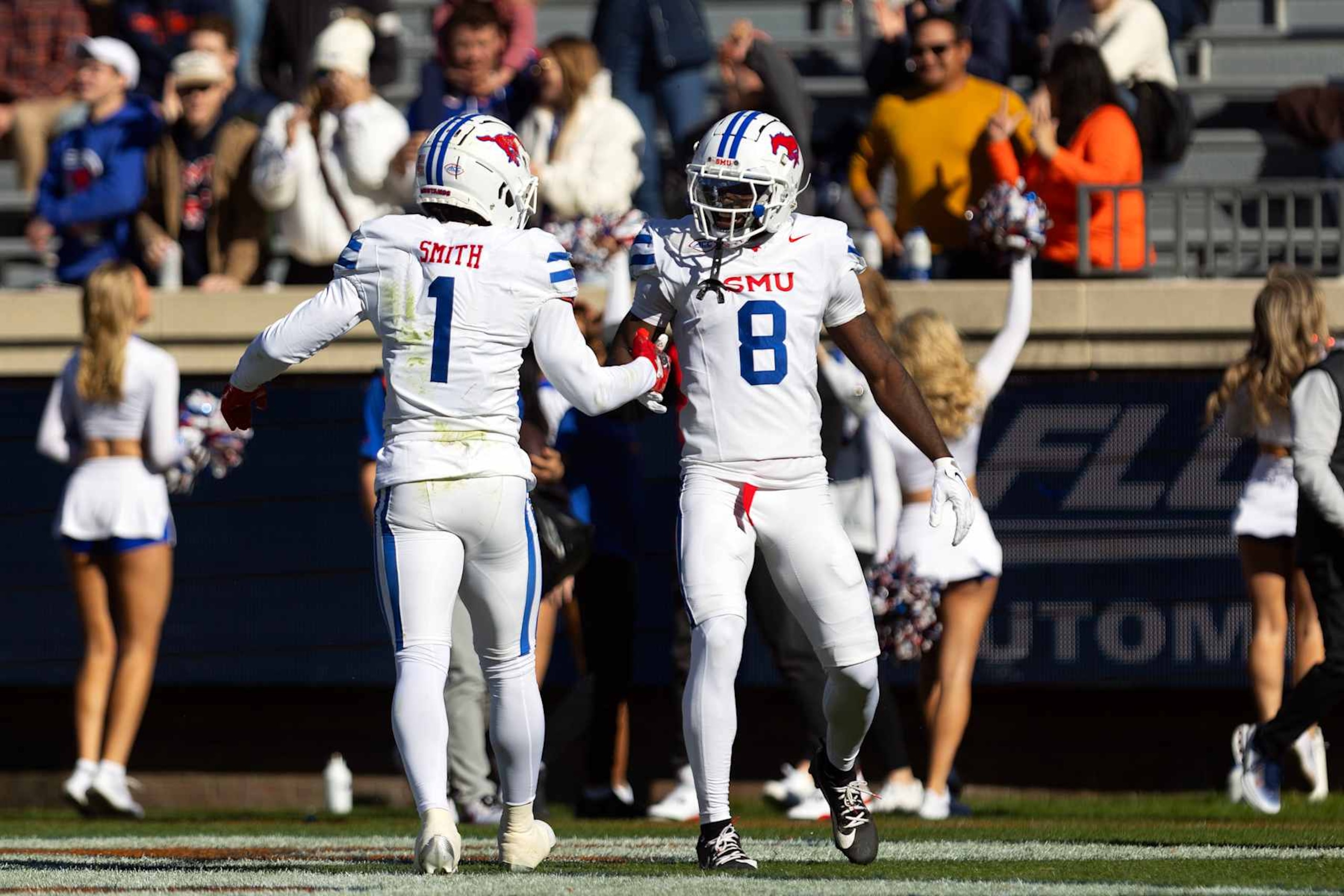 CHARLOTTESVILLE, VIRGINIA - NOVEMBER 23: Brashard Smith #1 and Jordan Hudson #8 of the Southern Methodist Mustangs celebrate a touchdown in the first half during a game against Virginia Cavaliers at Scott Stadium on November 23, 2024 in Charlottesville, Virginia. (Photo by Ryan M. Kelly/Getty Images)