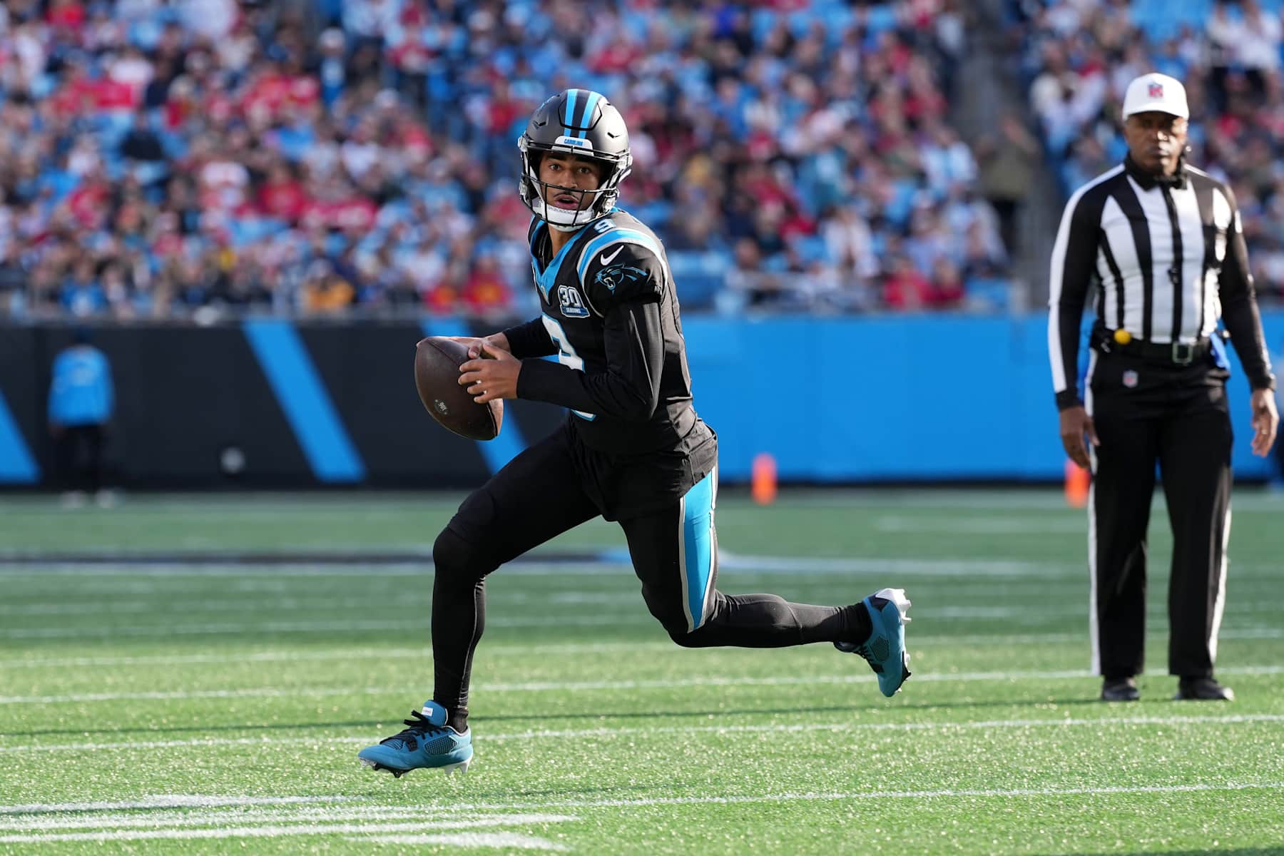 CHARLOTTE, NORTH CAROLINA - NOVEMBER 24: Quarterback Bryce Young #9 of the Carolina Panthers rolls out of the pocket during the third quarter against the Kansas City Chiefs at Bank of America Stadium on November 24, 2024 in Charlotte, North Carolina. (Photo by Grant Halverson/Getty Images)