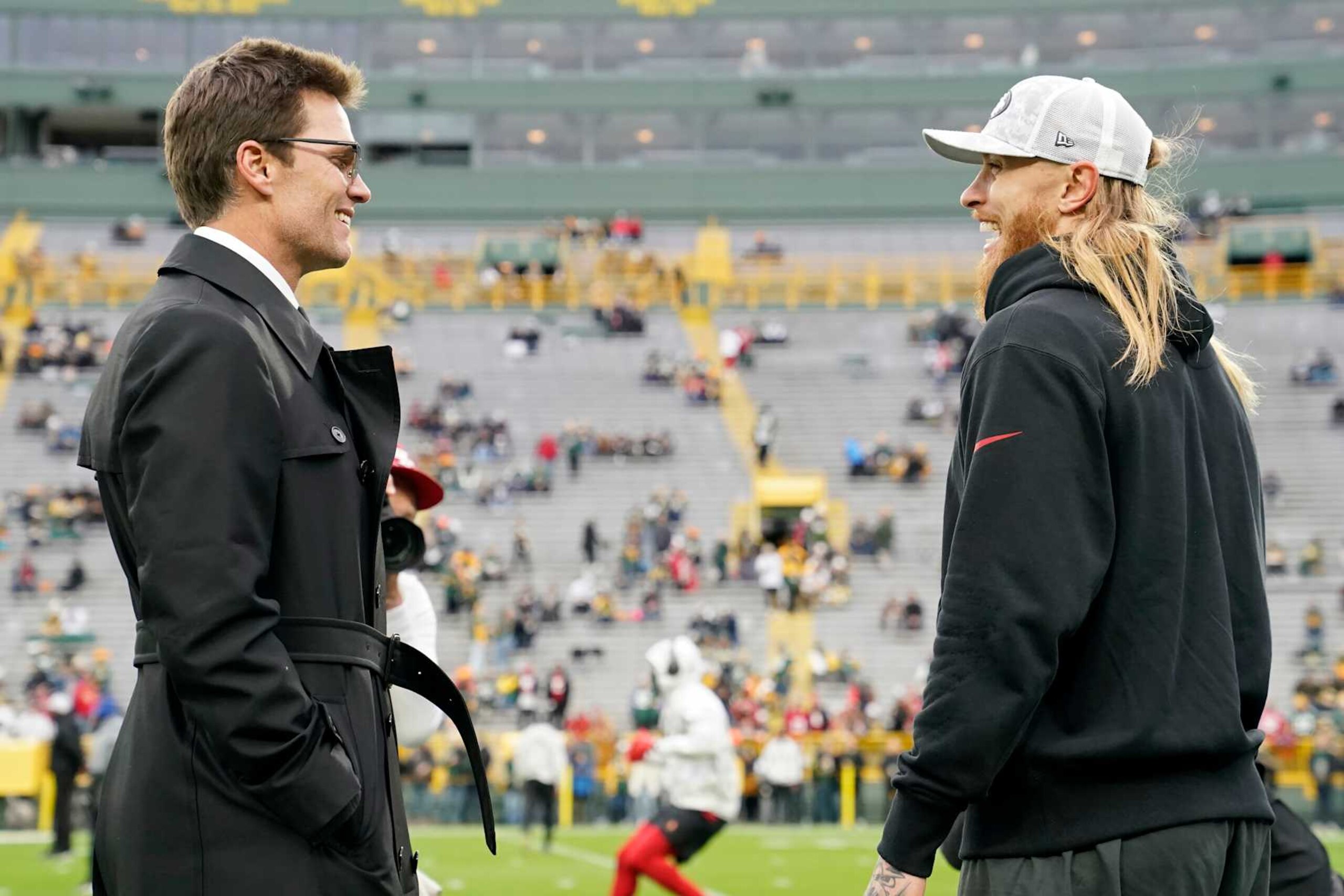 GREEN BAY, WISCONSIN - NOVEMBER 24: Tom Brady (L) and George Kittle #85 of the San Francisco 49ers meet before the game between the San Francisco 49ers and the Green Bay Packers at Lambeau Field on November 24, 2024 in Green Bay, Wisconsin. (Photo by Patrick McDermott/Getty Images)