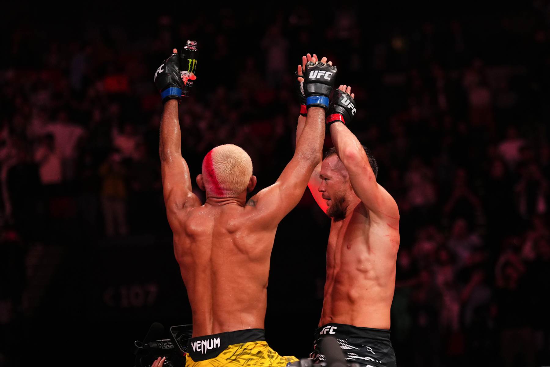 From left, Deiveson Figueiredo and Petr Yan scale the cage after their five-round fight in Macau. 