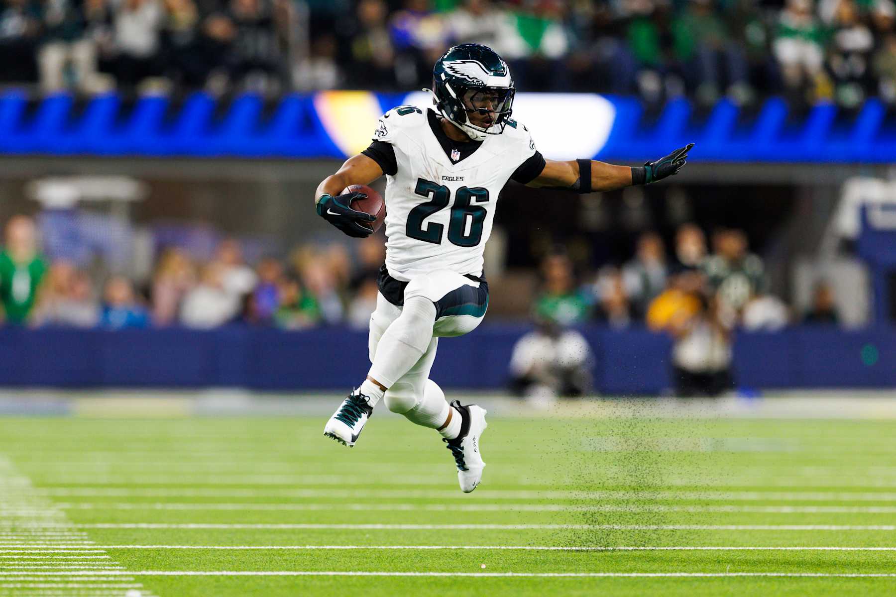 INGLEWOOD, CALIFORNIA - NOVEMBER 24: Saquon Barkley #26 of the Philadelphia Eagles runs with the ball during the first half against the Los Angeles Rams at SoFi Stadium on November 24, 2024 in Inglewood, California. (Photo by Ric Tapia/Getty Images)