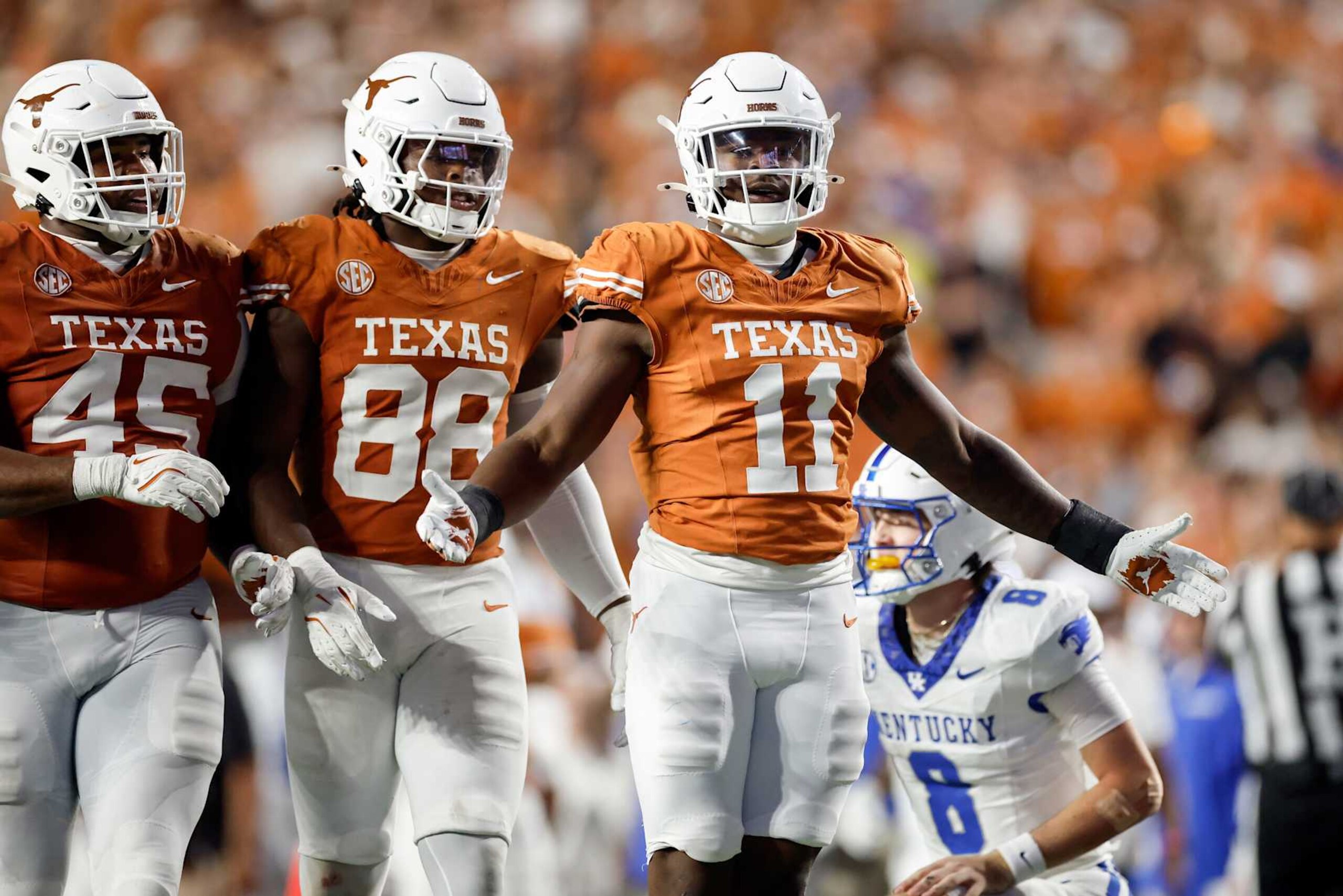 AUSTIN, TEXAS - NOVEMBER 23: Colin Simmons #11 of the Texas Longhorns celebrates with Barryn Sorrell #88 and Vernon Broughton #45 in the second half against the Kentucky Wildcats at Darrell K Royal-Texas Memorial Stadium on November 23, 2024 in Austin, Texas. (Photo by Tim Warner/Getty Images) AUSTIN, TEXAS - NOVEMBER 23: Colin Simmons #11 of the Texas Longhorns celebrates with Barryn Sorrell #88 and Vernon Broughton #45 in the second half against the Kentucky Wildcats at Darrell K Royal-Texas Memorial Stadium on November 23, 2024 in Austin, Texas. (Photo by Tim Warner/Getty Images)