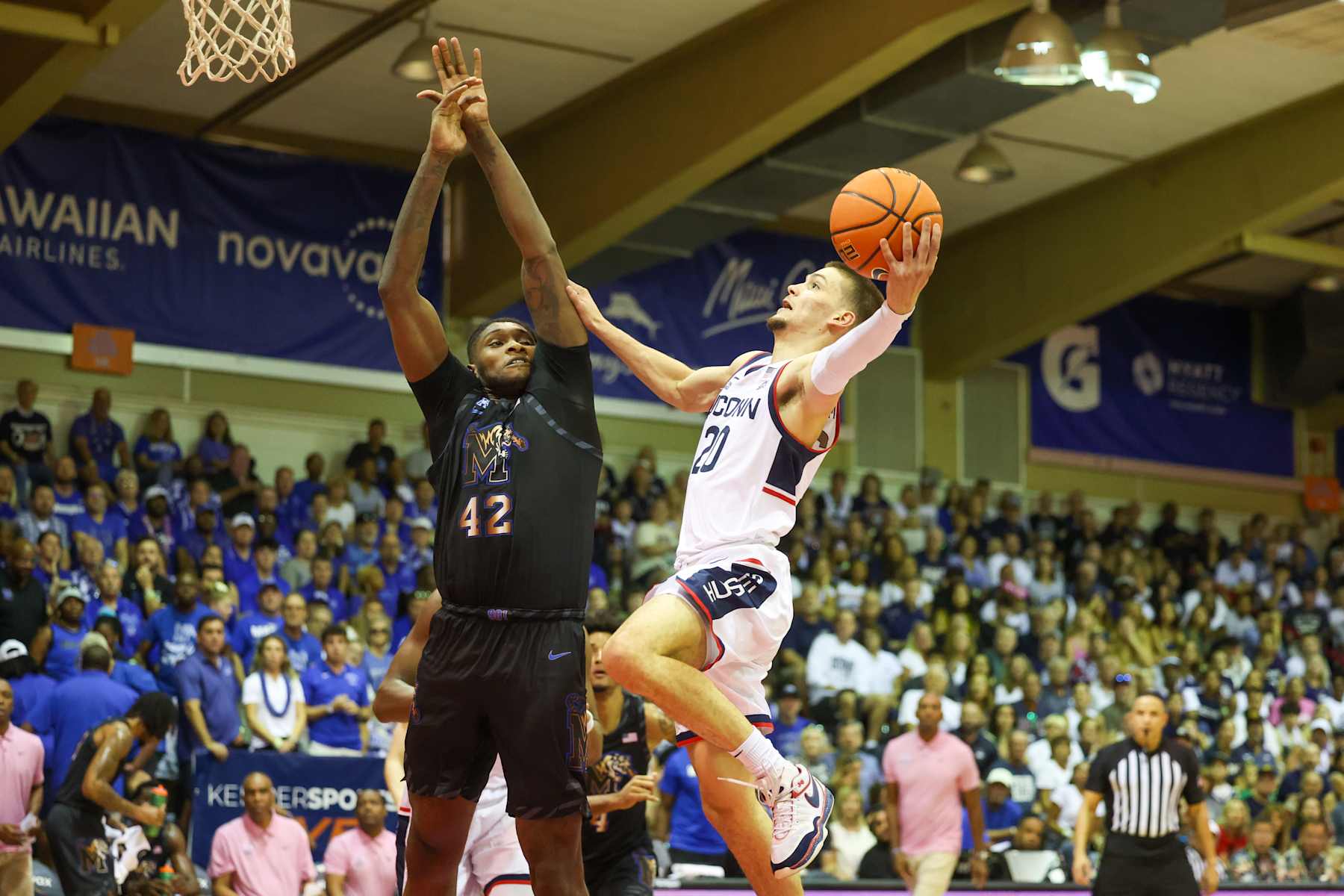 LAHAINA, HAWAII - NOVEMBER 25: Aidan Mahaney #20 of the Connecticut Huskies  attempts a layup as he is defended by Dain Dainja #42 of the Memphis Tigers during the first half of the Maui Invitational at the Lahaina Civic Center on November 25, 2024 in Lahaina, Hawaii. (Photo by Darryl Oumi/Getty Images)