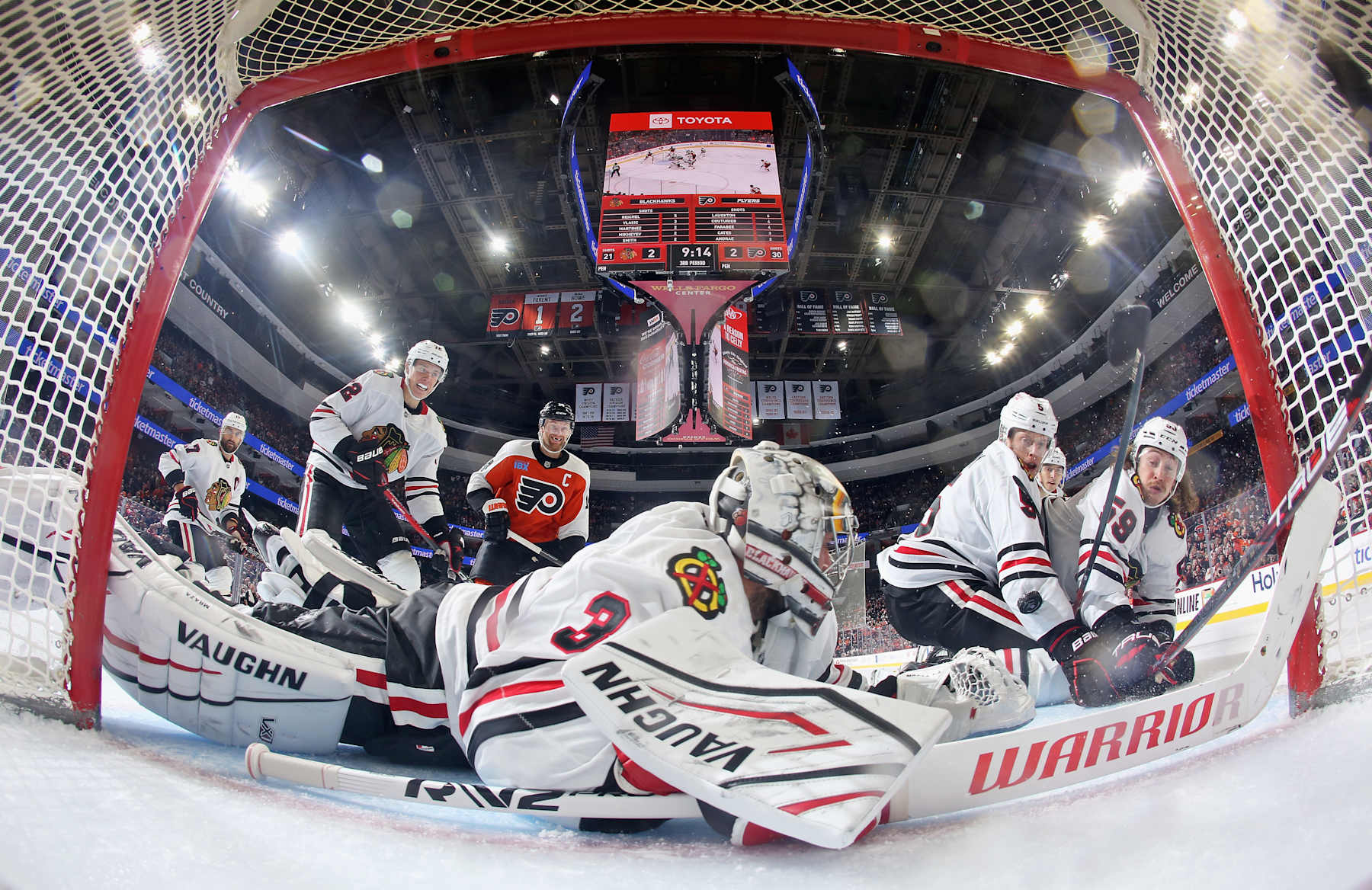 PHILADELPHIA, PENNSYLVANIA - NOVEMBER 23: Goaltender Petr Mrazek #34 of the Chicago Blackhawks lunges across his crease as teammates Nick Foligno #17, Alex Vlasic #72, Connor Murphy #5, and Tyler Bertuzzi #59 defend against Sean Couturier #14 of the Philadelphia Flyers at the Wells Fargo Center on November 23, 2024 in Philadelphia, Pennsylvania. The Flyers went on to defeat the Blackhawks 3-2 in overtime. (Photo by Len Redkoles/NHLI via Getty Images)