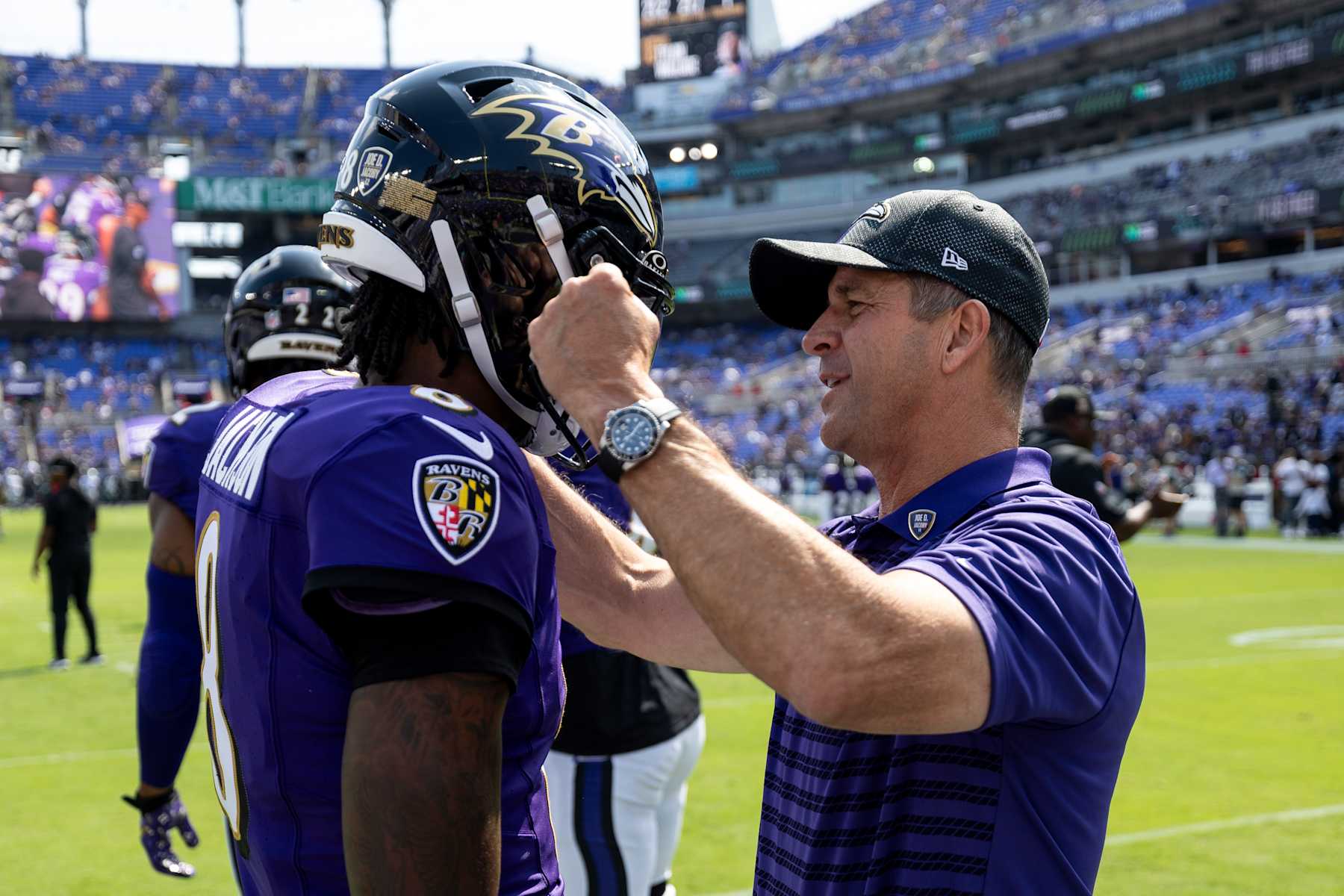 BALTIMORE, MARYLAND - SEPTEMBER 15: Lamar Jackson #8 of the Baltimore Ravens and head coach John Harbaugh of the Baltimore Ravens share a moment prior to an NFL football game against the Las Vegas Raiders at M&T Bank Stadium on September 15, 2024 in Baltimore, Maryland. (Photo by Michael Owens/Getty Images)