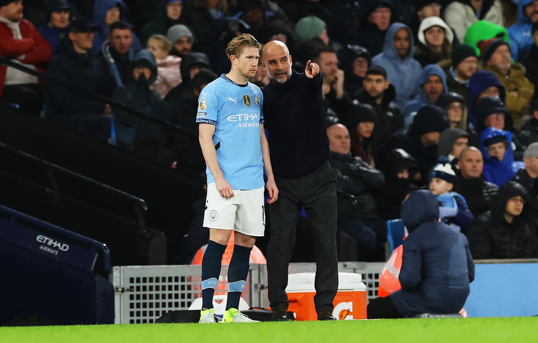 MANCHESTER, ENGLAND - NOVEMBER 23: Pep Guardiola, Manager of Manchester City, gives instructions to Kevin De Bruyne of Manchester City during the Premier League match between Manchester City FC and Tottenham Hotspur FC at Etihad Stadium on November 23, 2024 in Manchester, England. (Photo by Carl Recine/Getty Images)