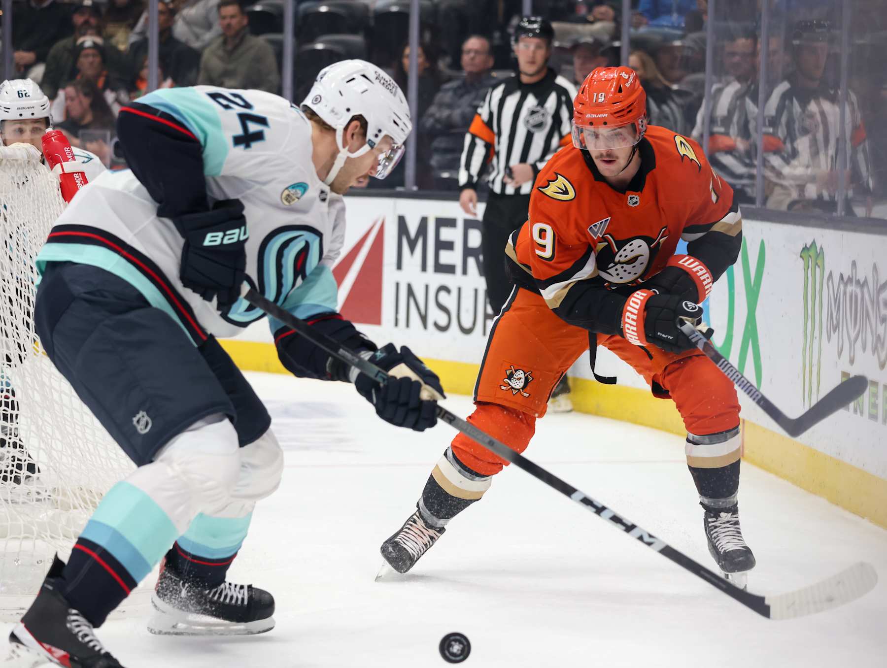 ANAHEIM, CA - NOVEMBER 25: Jamie Oleksiak #24 of the Seattle Kraken and Troy Terry #19 of the Anaheim Ducks battle for the puck during the first period at Honda Center on November 25, 2024 in Anaheim, California. (Photo by Debora Robinson/NHLI via Getty Images)