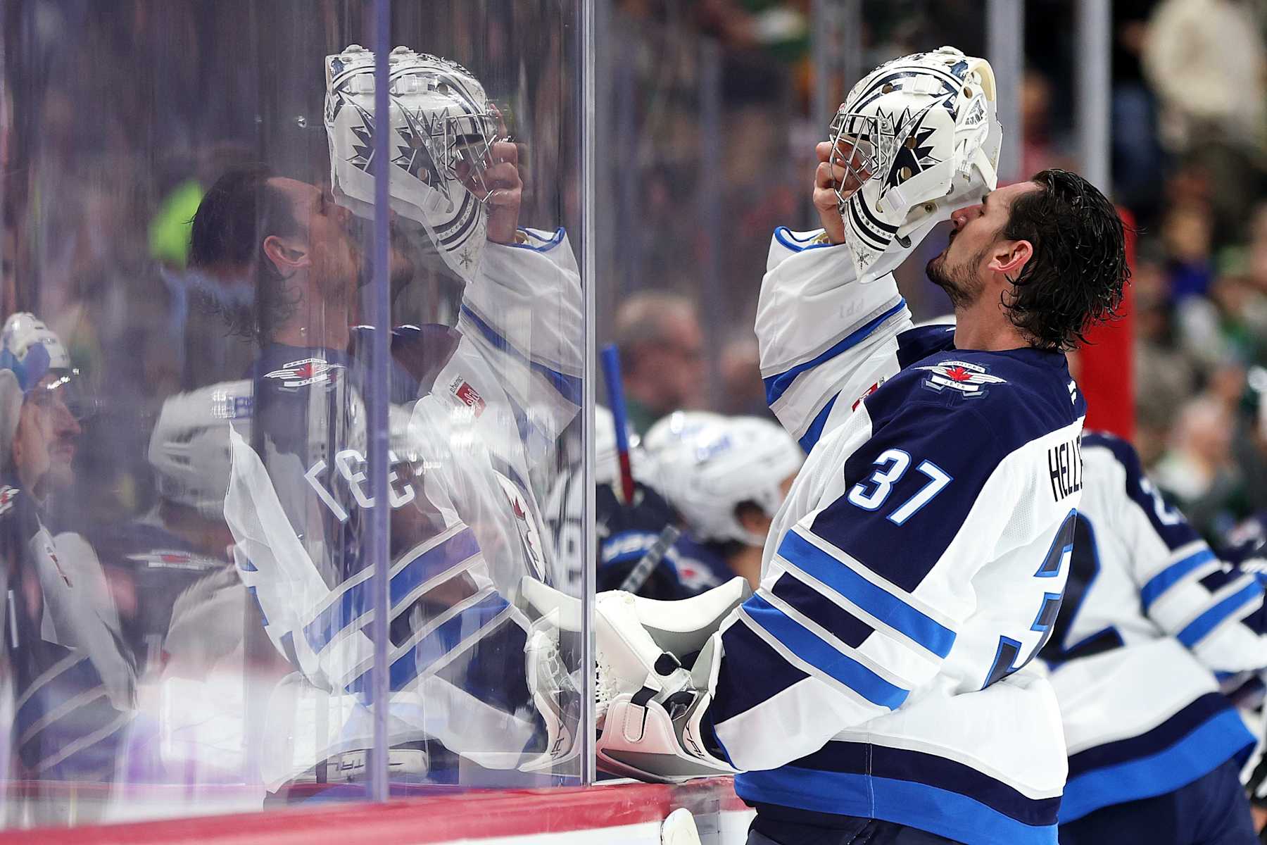 ST PAUL, MINNESOTA - NOVEMBER 25: Connor Hellebuyck #37 of the Winnipeg Jets puts his helmet on in the second period against the Minnesota Wild at Xcel Energy Center on November 25, 2024 in St Paul, Minnesota. (Photo by David Berding/Getty Images)