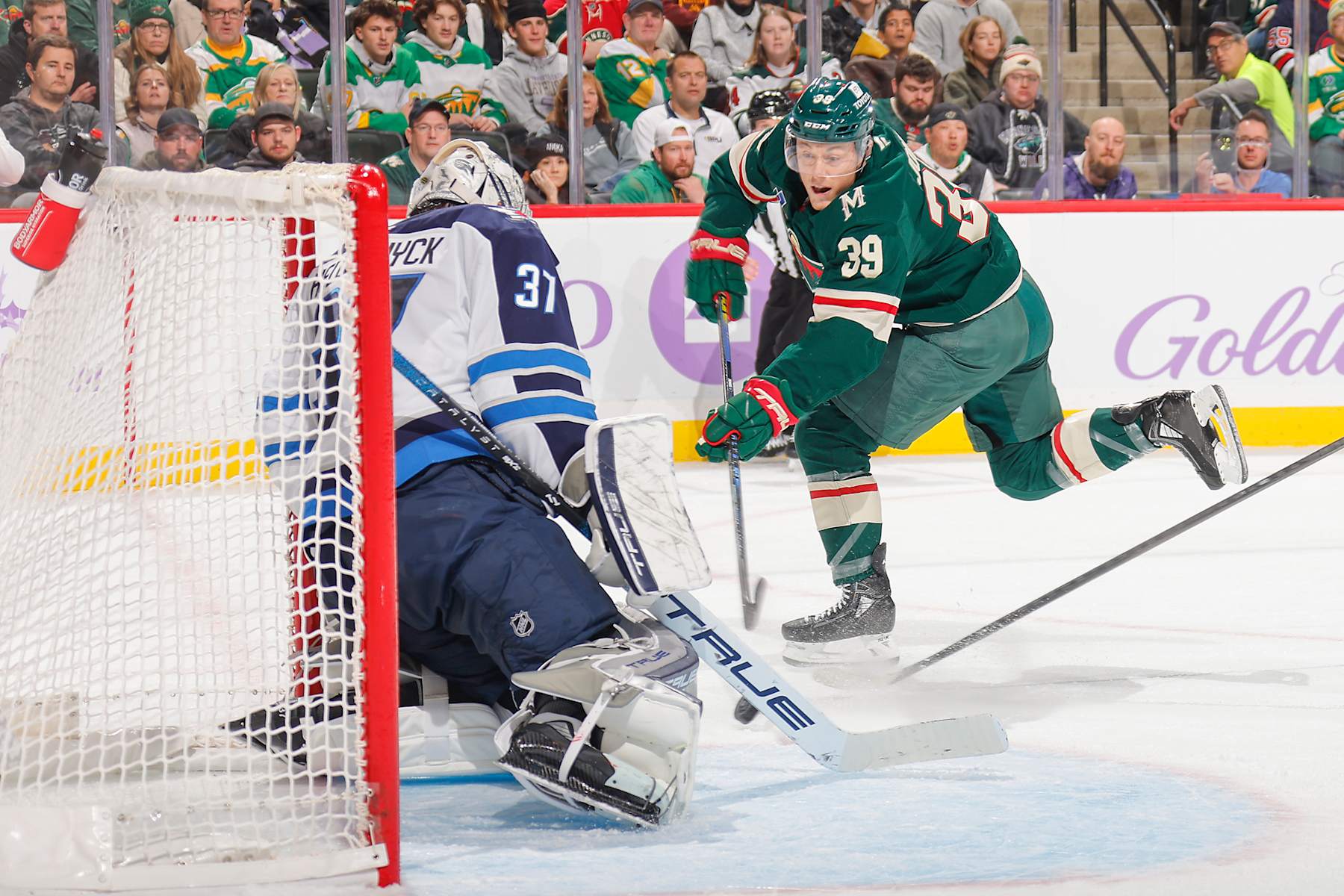 SAINT PAUL, MN - NOVEMBER 25: Connor Hellebuyck #37 of the Winnipeg Jets makes a save against Ben Jones #39 of the Minnesota Wild during the game at the Xcel Energy Center on November 25, 2024 in Saint Paul, Minnesota. (Photo by Bruce Kluckhohn/NHLI via Getty Images)