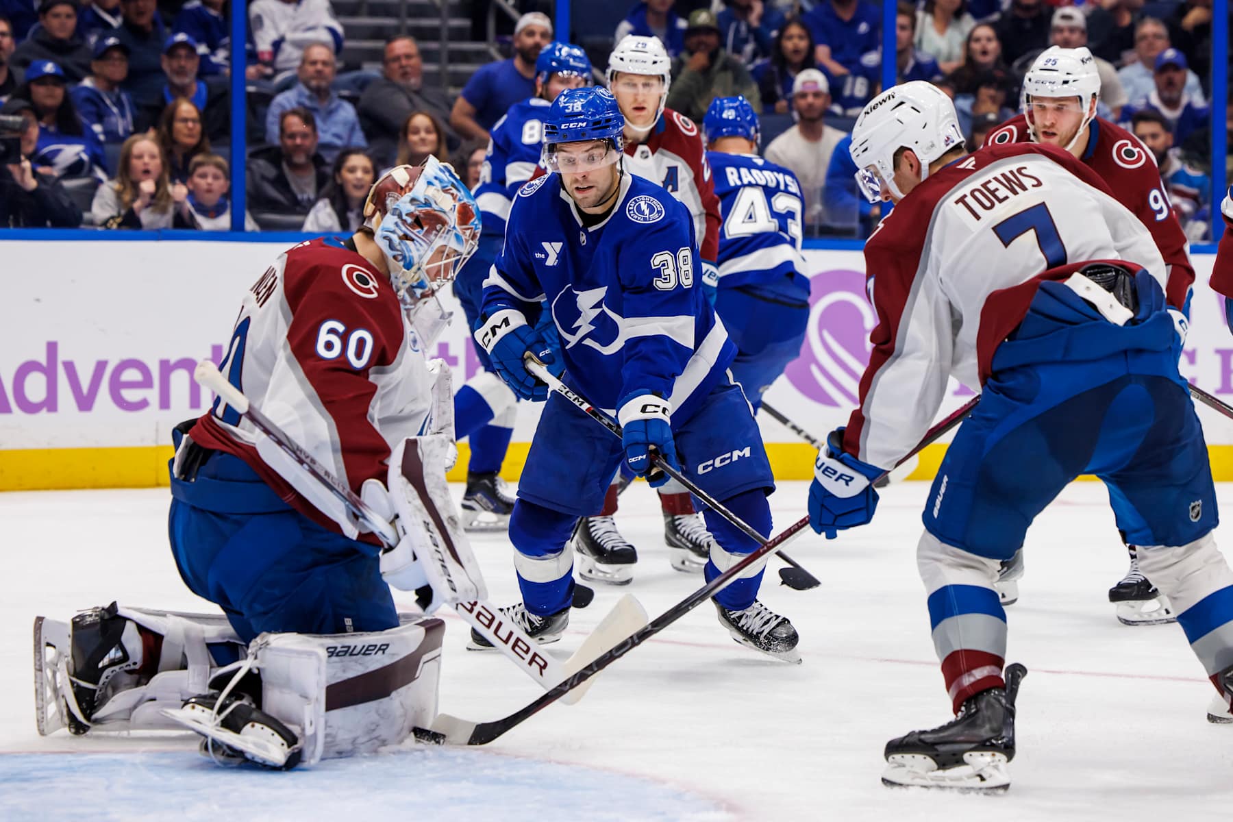 TAMPA, FL - NOVEMBER 25: Brandon Hagel #38 of the Tampa Bay Lightning looks for the puck against goalie Justus Annunen #60 and Devon Toews #7 of the Colorado Avalanche at Amalie Arena on November 25, 2024 in Tampa, Florida. (Photo by Mark LoMoglio/NHLI via Getty Images)
