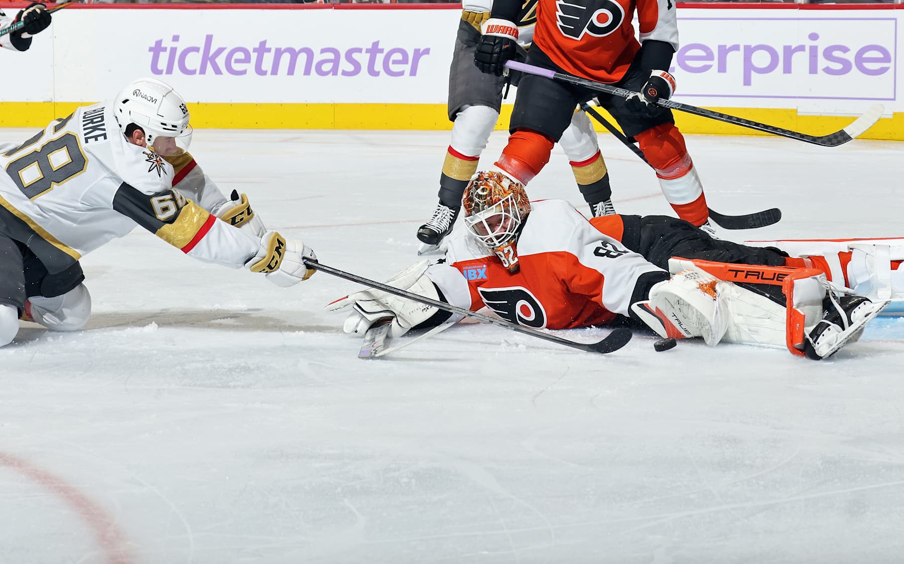 PHILADELPHIA, PENNSYLVANIA - NOVEMBER 25: Goaltender Ivan Fedotov #82 of the Philadelphia Flyers lunges across his crease to make a glove save on a scoring chance by Callahan Burke #68 of the Vegas Golden Knights at the Wells Fargo Center on November 25, 2024 in Philadelphia, Pennsylvania. (Photo by Len Redkoles/NHLI via Getty Images)