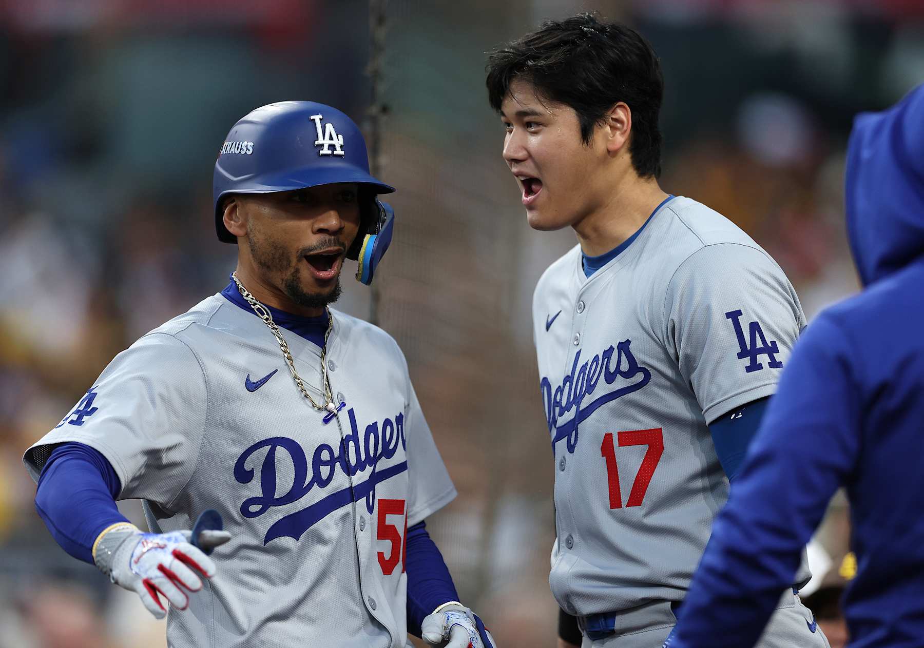 SAN DIEGO, CALIFORNIA - OCTOBER 08: Mookie Betts #50 
 and Shohei Ohtani #17 of the Los Angeles Dodgers celebrate after Betts hit a home run in the first inning against the San Diego Padres during Game Three of the Division Series at Petco Park on October 08, 2024 in San Diego, California. (Photo by Harry How/Getty Images)