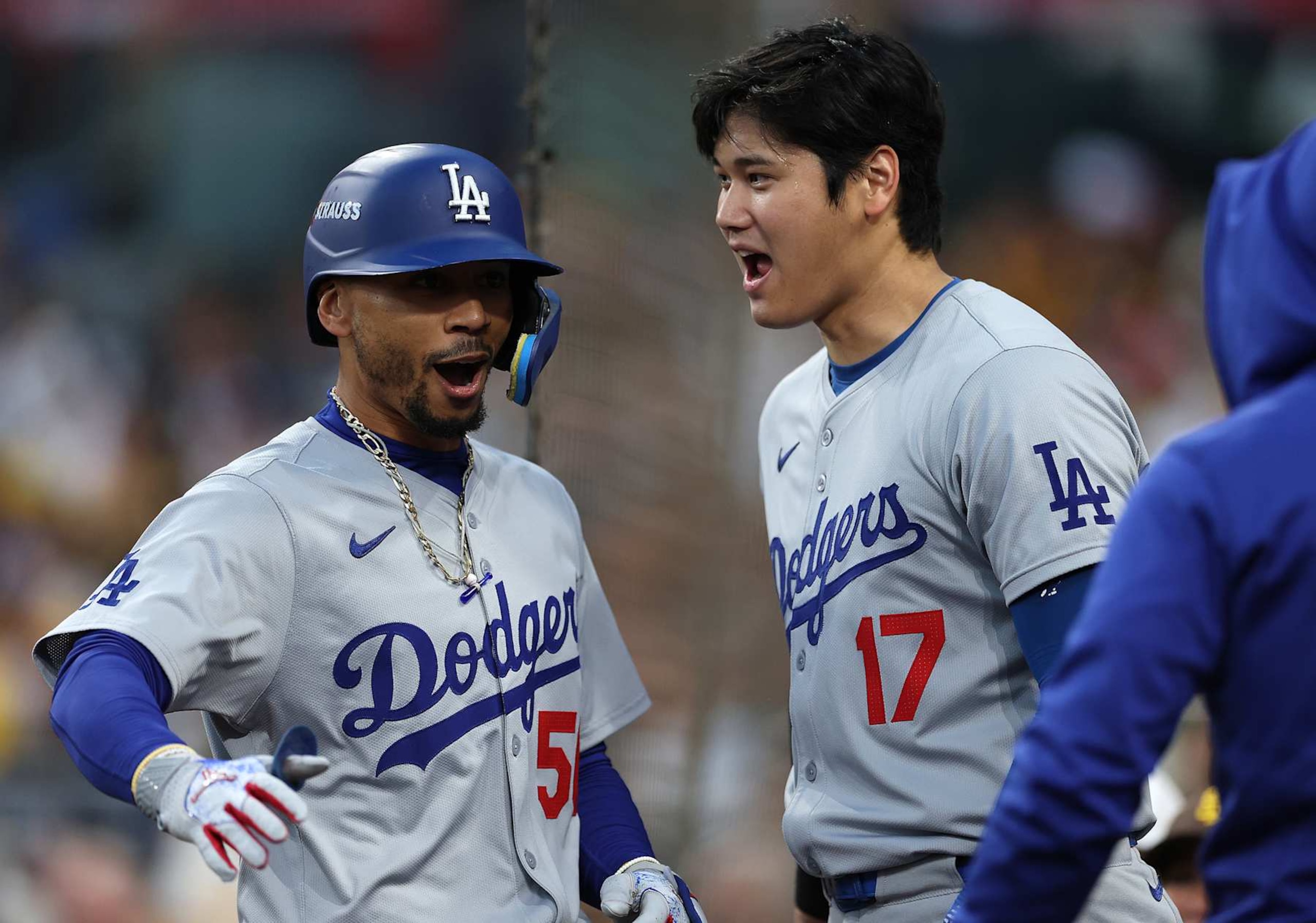 SAN DIEGO, CALIFORNIA - OCTOBER 08: Mookie Betts #50 
 and Shohei Ohtani #17 of the Los Angeles Dodgers celebrate after Betts hit a home run in the first inning against the San Diego Padres during Game Three of the Division Series at Petco Park on October 08, 2024 in San Diego, California. (Photo by Harry How/Getty Images)