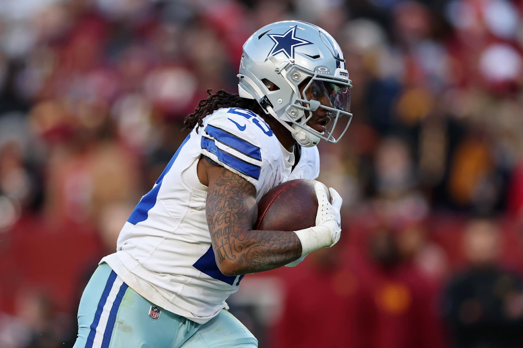 LANDOVER, MARYLAND - NOVEMBER 24: Rico Dowdle #23 of the Dallas Cowboys runs with the ball during the second half against the Washington Commanders at Northwest Stadium on November 24, 2024 in Landover, Maryland. (Photo by Patrick Smith/Getty Images)