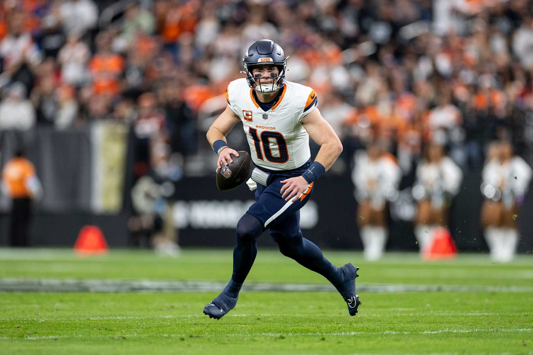 LAS VEGAS, NEVADA - NOVEMBER 24: Bo Nix #10 of the Denver Broncos scrambles and looks to pass during an NFL Football game against the Las Vegas Raiders at Allegiant Stadium on November 24, 2024 in Las Vegas, Nevada. (Photo by Michael Owens/Getty Images)