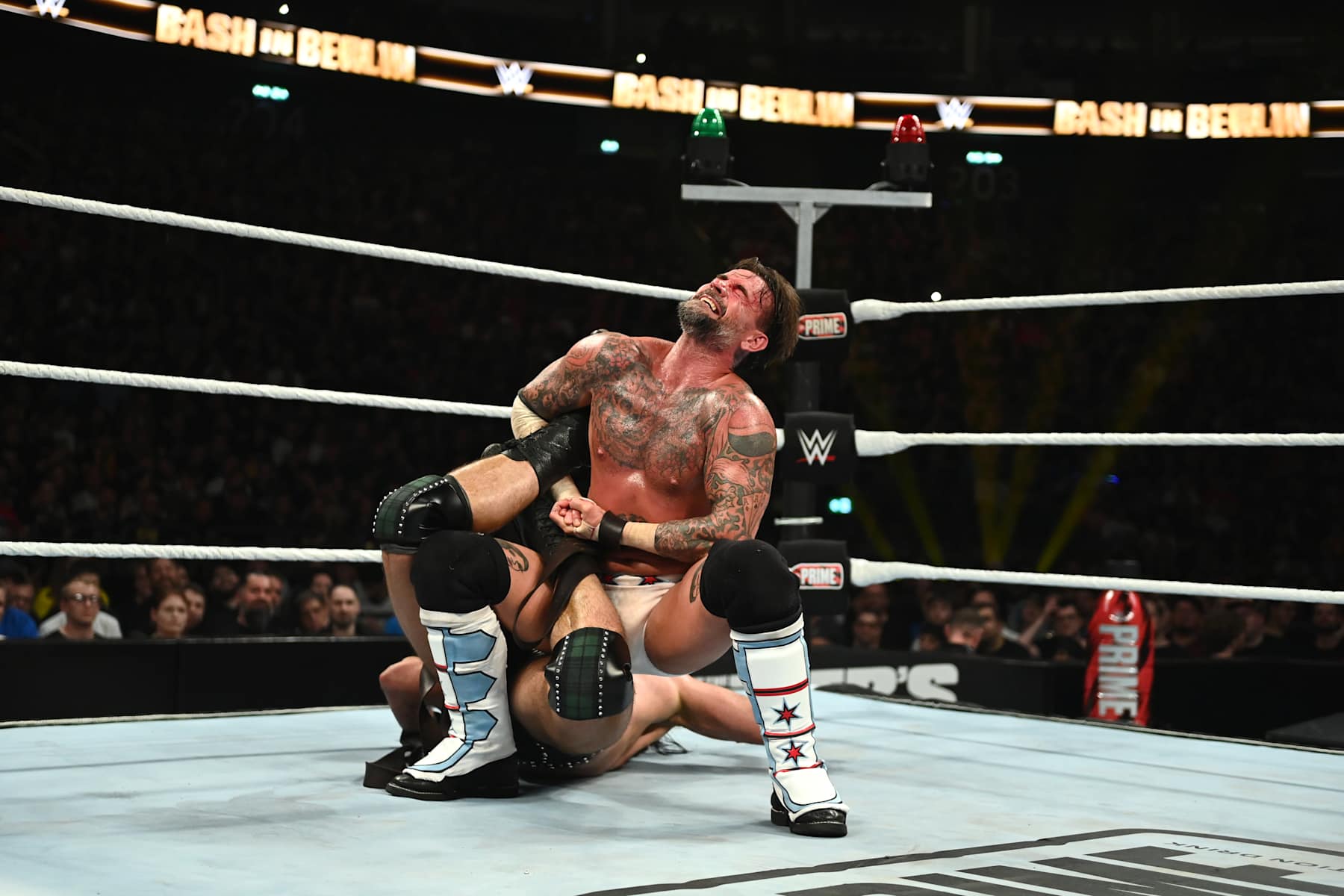 BERLIN, GERMANY - AUGUST 31: CM Punk locks in a sharpshooter against Drew McIntyre during their strap match at the WWE Bash in Berlin Premium Live Event at Uber Arena on August 31, 2024 in Berlin, Germany. (Photo by WWE/Getty Images)