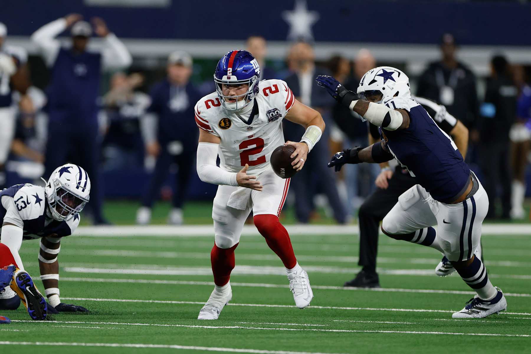 ARLINGTON, TEXAS - NOVEMBER 28: Drew Lock #2 of the New York Giants runs the ball against Micah Parsons #11 of the Dallas Cowboys during the first quarter at AT&T Stadium on November 28, 2024 in Arlington, Texas. (Photo by Ron Jenkins/Getty Images)