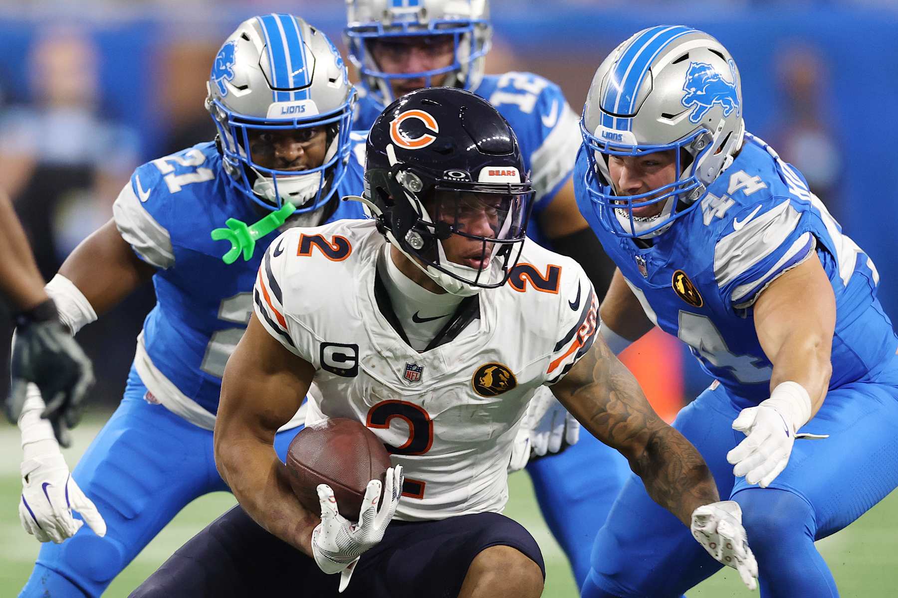 DETROIT, MICHIGAN - NOVEMBER 28: DJ Moore #2 of the Chicago Bears runs with the ball as Malcolm Rodriguez #44 and Amik Robertson #21 of the Detroit Lions look to make a tackle during the second quarter at Ford Field on November 28, 2024 in Detroit, Michigan. (Photo by Gregory Shamus/Getty Images)