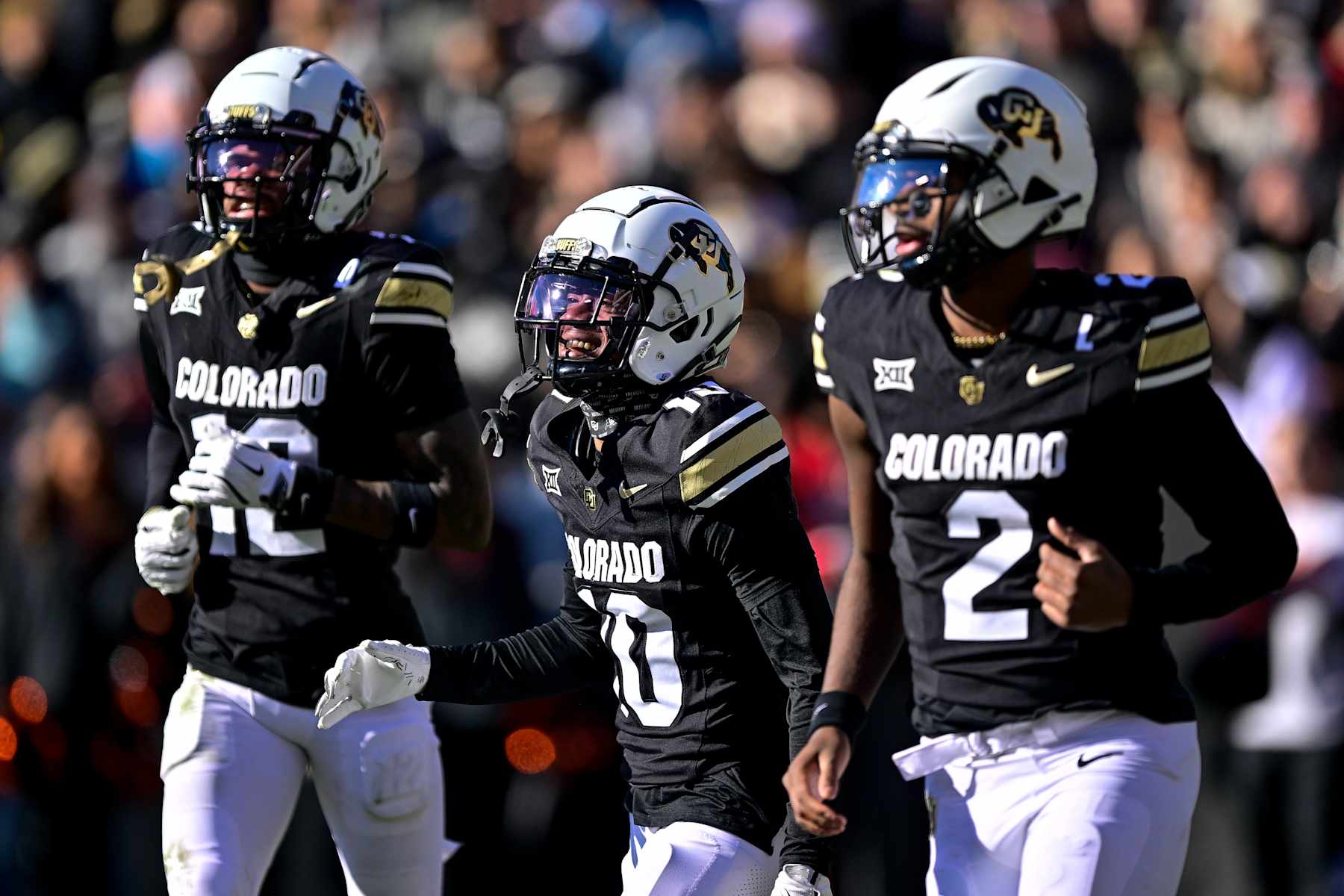 BOULDER, CO - NOVEMBER 29:  LaJohntay Wester #10 of the Colorado Buffaloes celebrates with Travis Hunter #12 and Shedeur Sanders #2 after his first quarter touchdown against the Oklahoma State Cowboys at Folsom Field on November 29, 2024 in Boulder, Colorado. (Photo by Dustin Bradford/Getty Images)