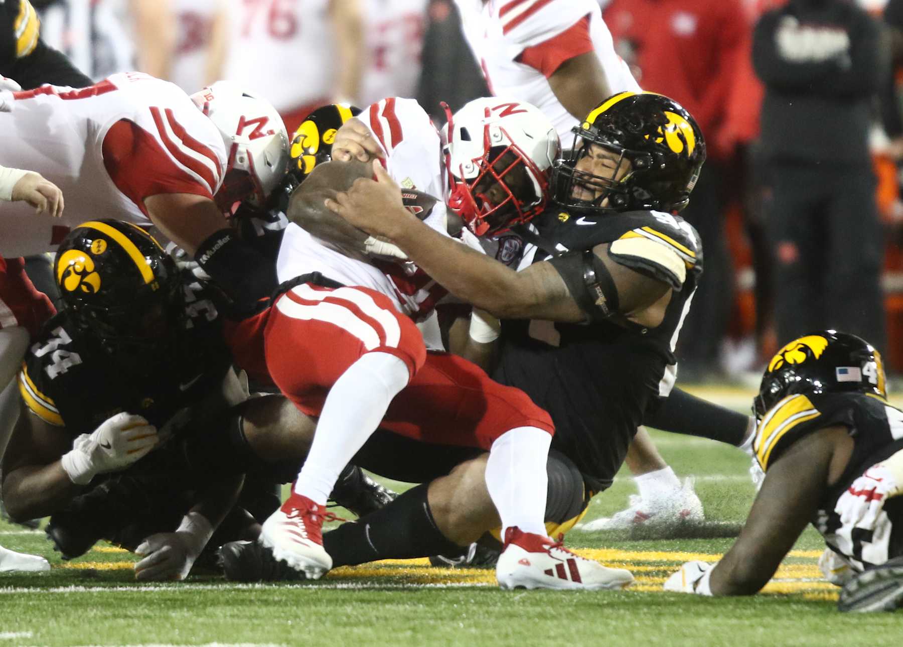 IOWA CITY, IOWA- NOVEMBER 29:  Running back Emmett Johnson #21 of the Nebraska Cornhuskers is brought down during the first half by defensive lineman Yahya Black #94 of the Iowa Hawkeyes, at Kinnick Stadium on November 29, 2024 in Iowa City, Iowa.  (Photo by Matthew Holst/Getty Images)