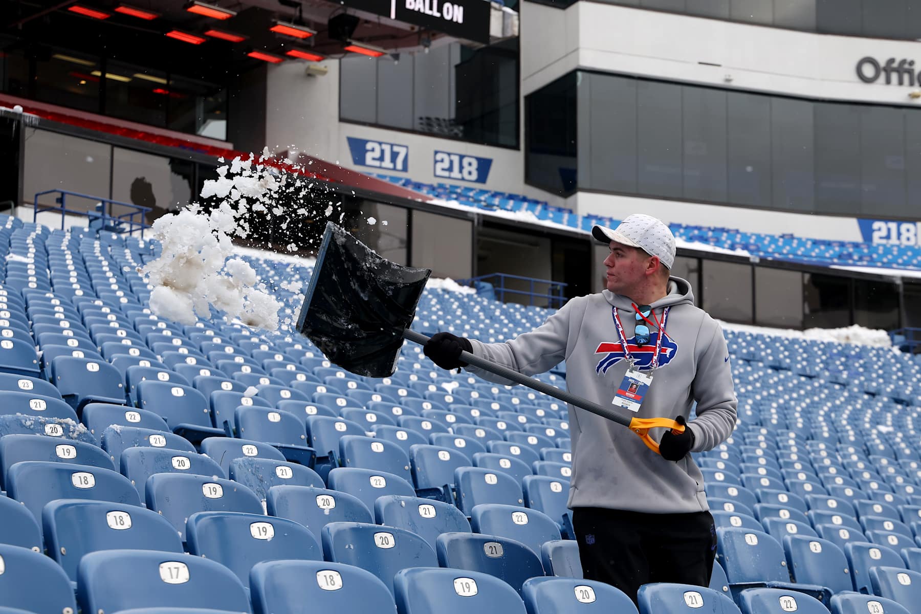 ORCHARD PARK, NEW YORK - JANUARY 21: Kadin Austin, Cleaning and General Maintenance Associate of the Buffalo Bills, shovels snow off the seats prior to the AFC Divisional Playoff game against the Kansas City Chiefs at Highmark Stadium on January 21, 2024 in Orchard Park, New York. (Photo by Timothy T Ludwig/Getty Images)