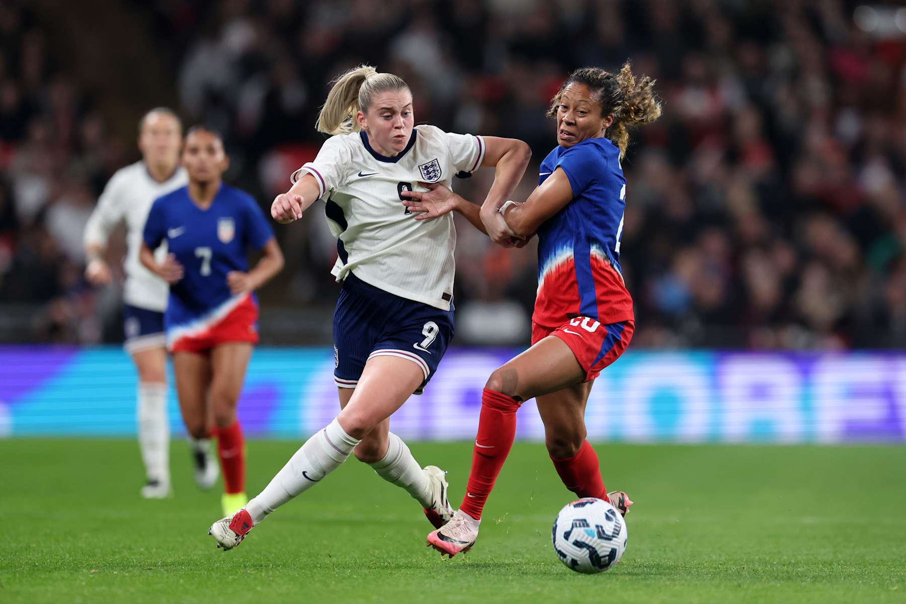 LONDON, ENGLAND - NOVEMBER 30: Alessia Russo of England battles for possession with Casey Krueger of United States during the Women's international friendly between England and the USA at Wembley Stadium on November 30, 2024 in London, England. (Photo by Catherine Ivill - AMA/Getty Images)