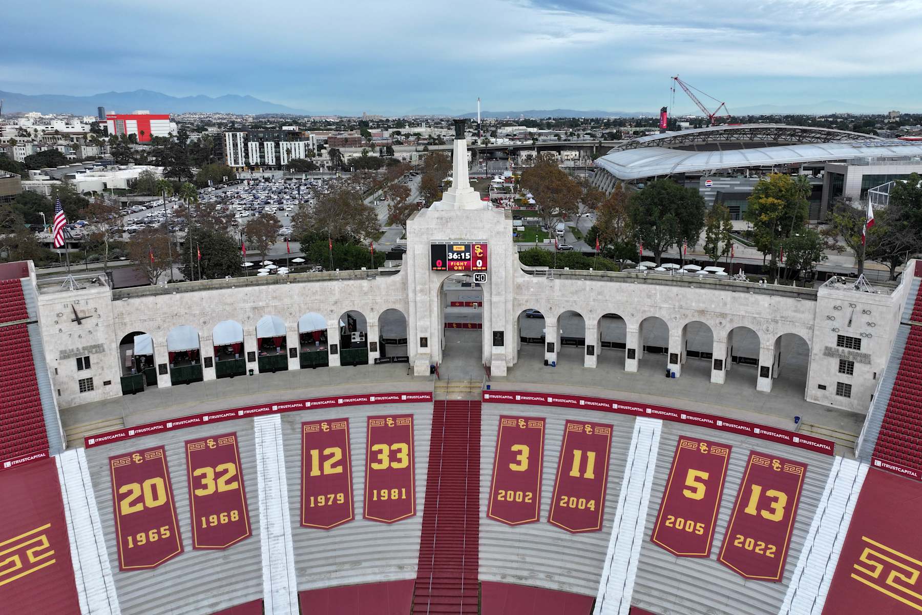 LOS ANGELES, CALIFORNIA - NOVEMBER 29: The retired jersey numbers of Southern California Trojans Heisman Trophy winners at the Los Angeles Memorial Coliseum peristyle on November 29, 2024 in Los Angeles, California. From left: Mike Garrett (20), O.J. Simpson (32), Charles White (12), Marcus Allen (33), Carson Palmer (3), Matt Leinart (11), Reggie Bush (5) and Caleb Williams (13).  (Photo by Kirby Lee/Getty Images)
