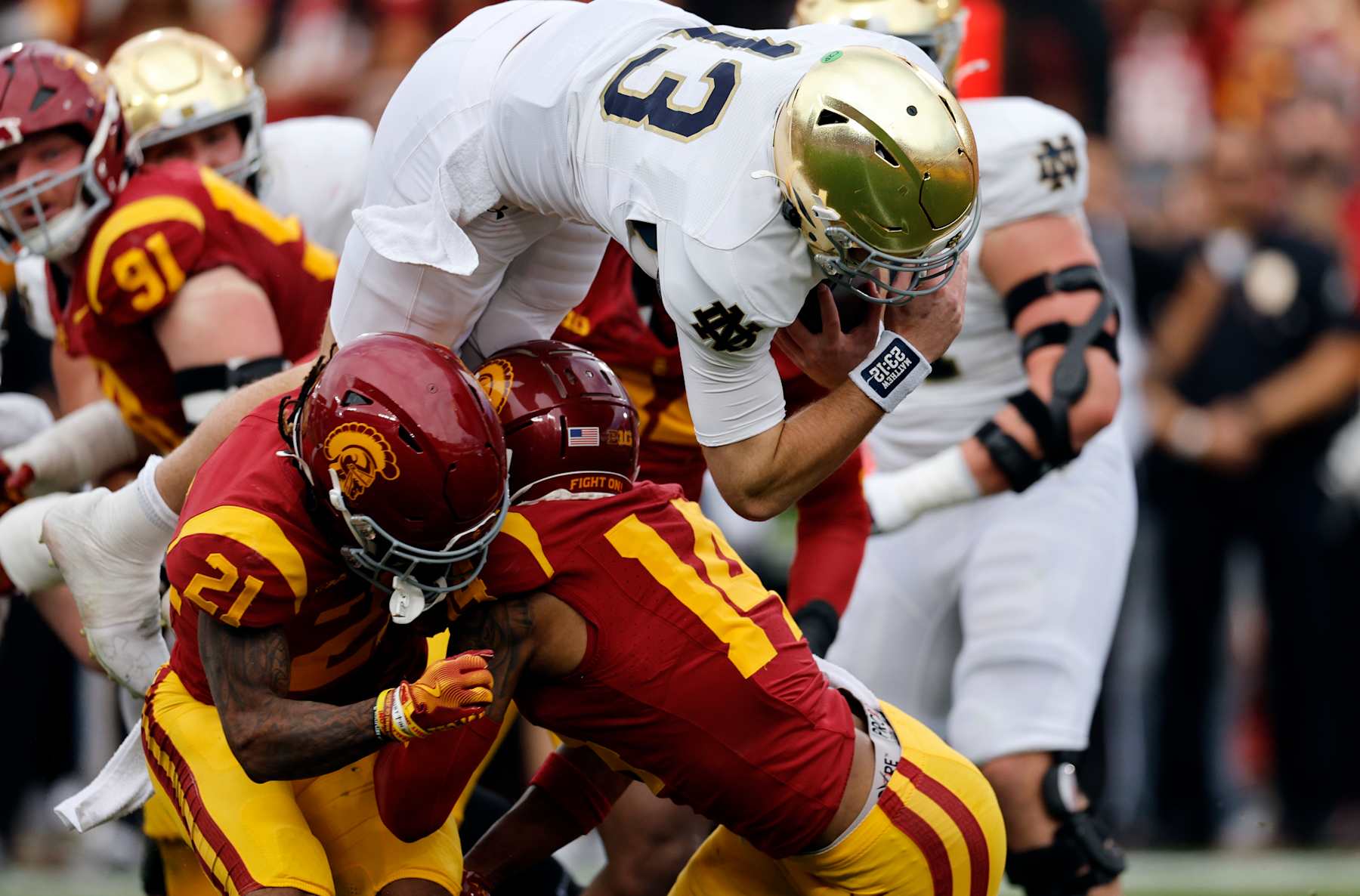 LOS ANGELES, CALIFORNIA - NOVEMBER 30: Quarterback Riley Leonard #13 of the Notre Dame Fighting dives for the end zone as he is stopped by cornerback Jacobe Covington #14 of the USC Trojans during the first half at United Airlines Field at the Los Angeles Memorial Coliseum on November 30, 2024 in Los Angeles, California. (Photo by Kevork Djansezian/Getty Images)