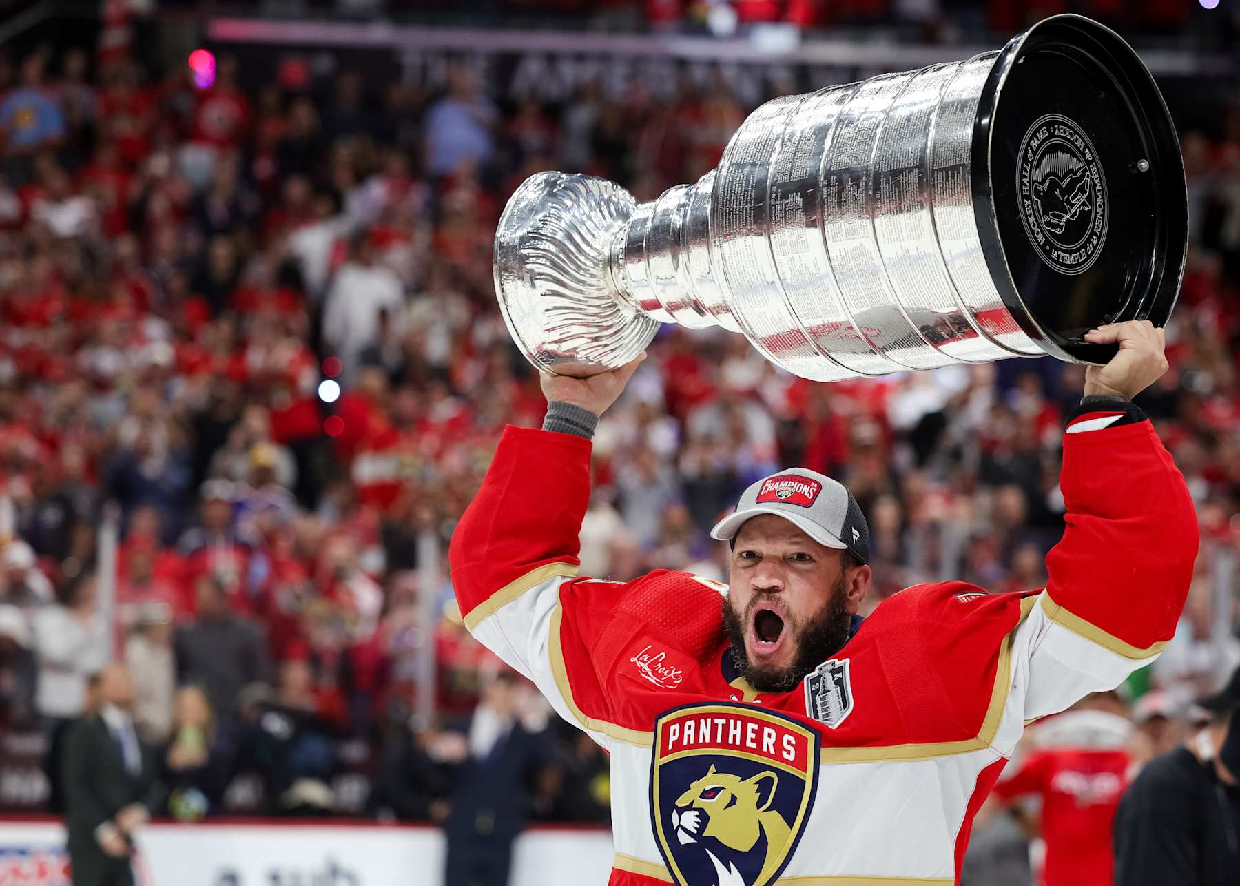 SUNRISE, FLORIDA - JUNE 24: Kyle Okposo #8 of the Florida Panthers hoists the Stanley Cup after Florida's 2-1 victory against the Edmonton Oilers in Game Seven of the 2024 Stanley Cup Final at Amerant Bank Arena on June 24, 2024 in Sunrise, Florida. (Photo by Carmen Mandato/Getty Images)