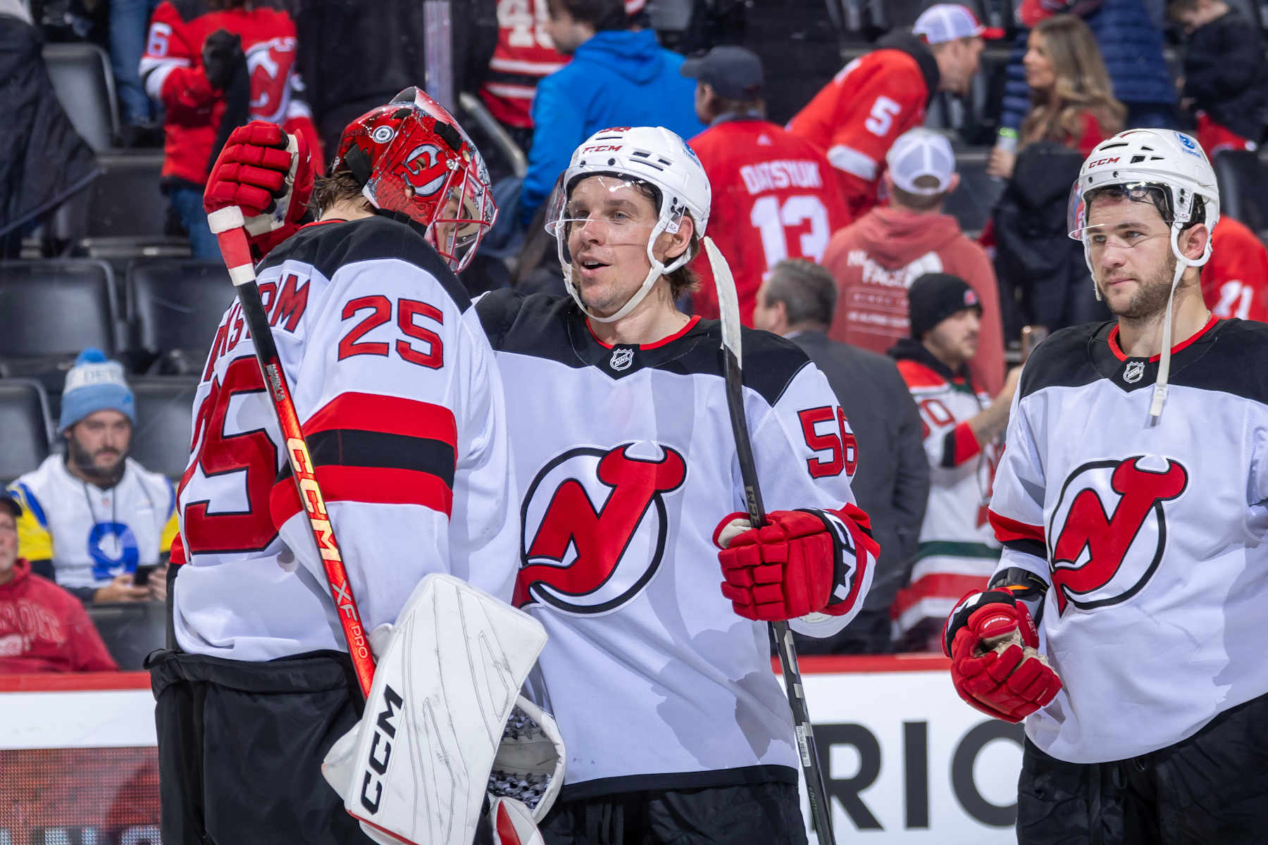DETROIT, MICHIGAN - NOVEMBER 29: Jacob Markstrom (25) of the New Jersey Devils celebrates the victory over the Detroit Red Wings with Erik Haula (56) at the end of the third period at Little Caesars Arena on November 29, 2024 in Detroit, Michigan. New Jersey defeated Detroit 5-4. (Photo by Dave Reginek/NHLI via Getty Images)