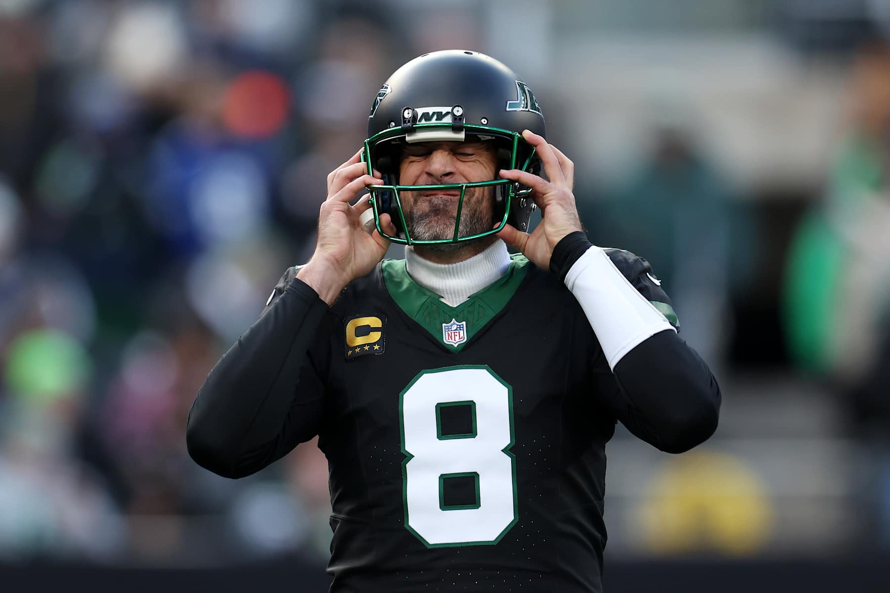 EAST RUTHERFORD, NEW JERSEY - DECEMBER 01: Aaron Rodgers #8 of the New York Jets puts on his helmet during the first quarter of a game against the Seattle Seahawks at MetLife Stadium on December 01, 2024 in East Rutherford, New Jersey. (Photo by Luke Hales/Getty Images)