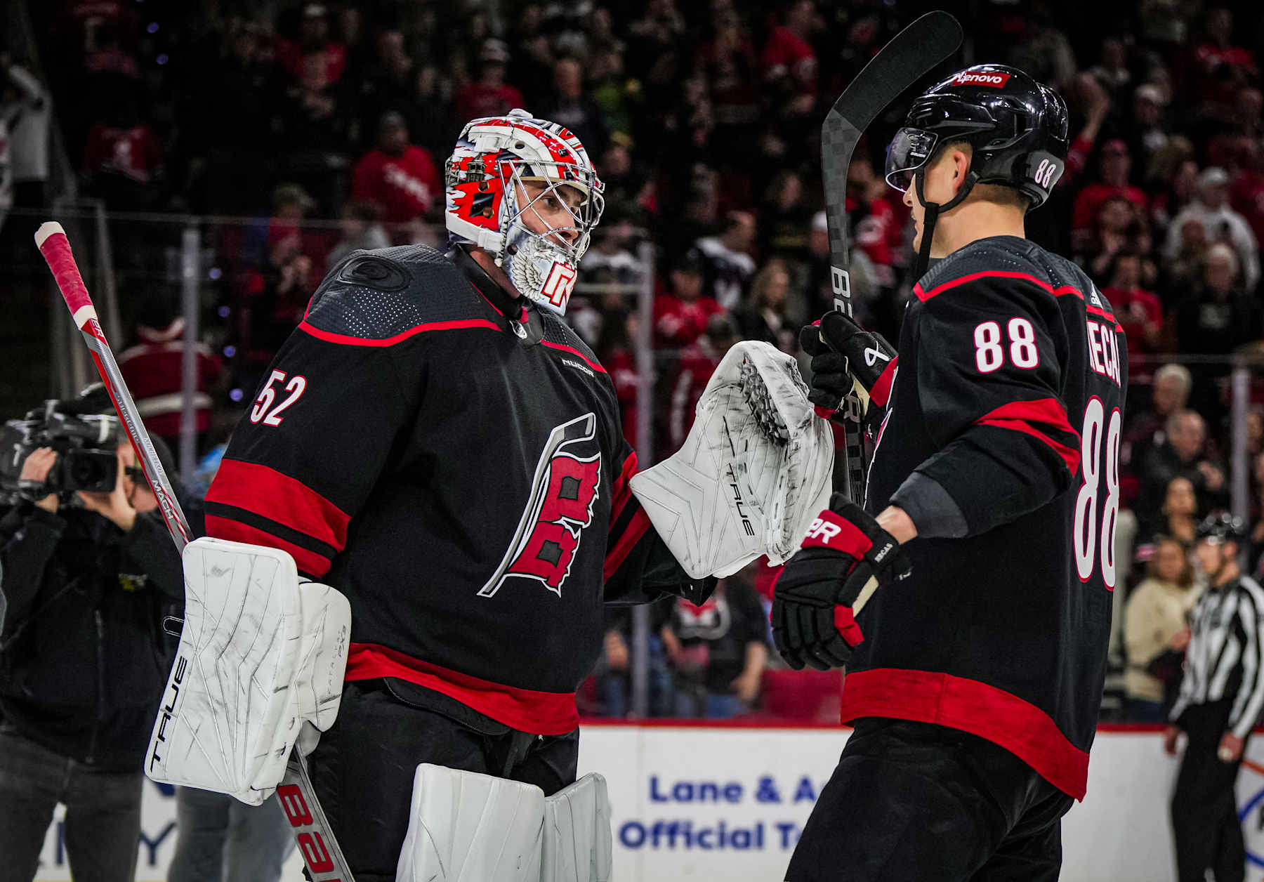 RALEIGH, NORTH CAROLINA - APRIL 05: Pyotr Kochetkov #52 of the Carolina Hurricanes celebrates with Martin Necas #88 after a 4-2 victory against the Washington Capitals at PNC Arena on April 5, 2024 in Raleigh, North Carolina. (Photo by Josh Lavallee/NHLI via Getty Images)