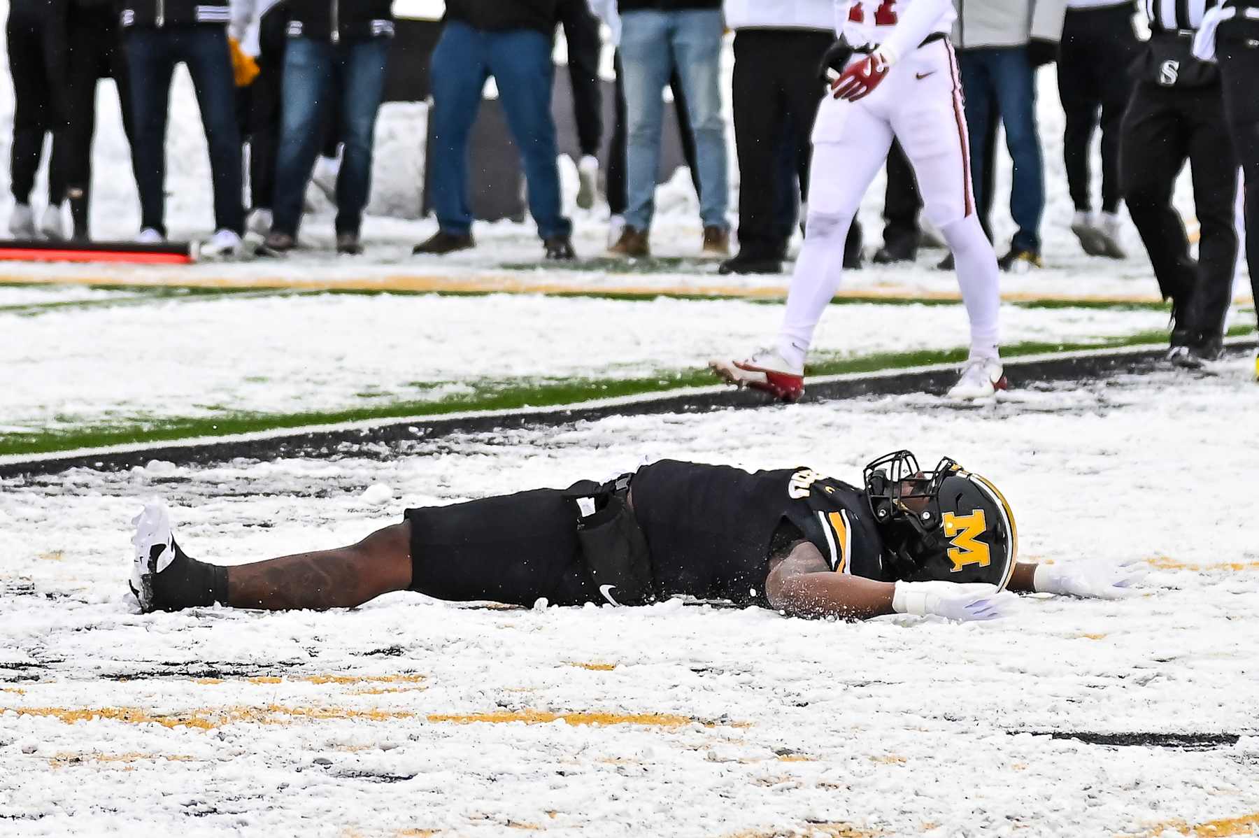 COLUMBIA, MO - NOVEMBER 30: Missouri Tigers running back Marcus Carroll (9) does a snow angle in celebration of his touchdown during a SEC conference game between the Arkansas Razorbacks and the Missouri Tigers held on Saturday Nov 30, 2024 at Faurot Field at Memorial Stadium in Columbia MO. (Photo by Rick Ulreich/Icon Sportswire via Getty Images